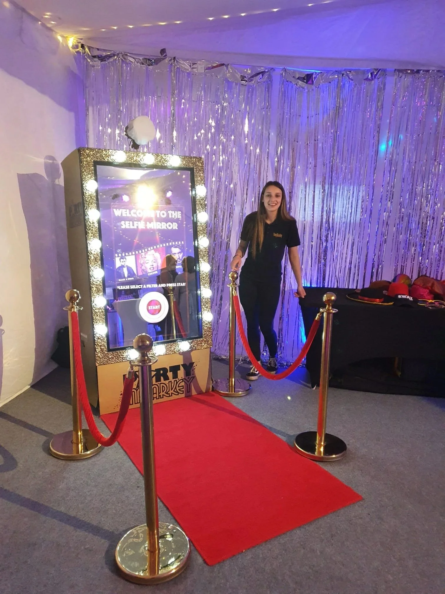 Selfie mirror photo booth setup at a luxury event venue