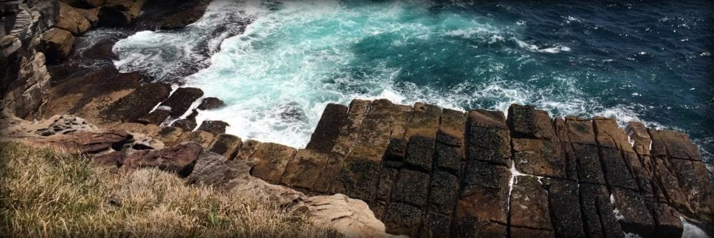 Beach waves crashing on a rocky seashore