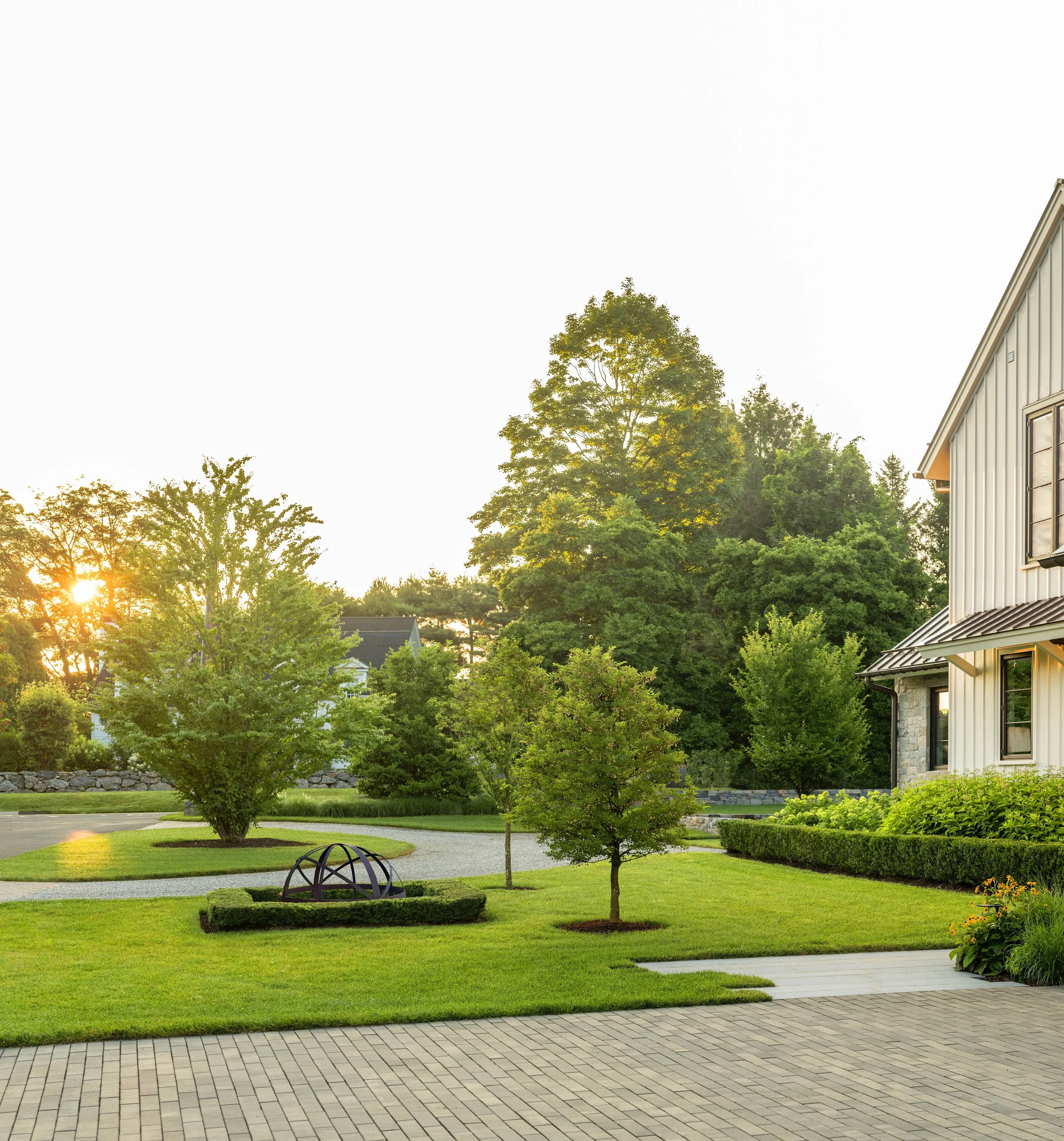 Permeable paving driveway with specimen trees, sculpture and parterre planting