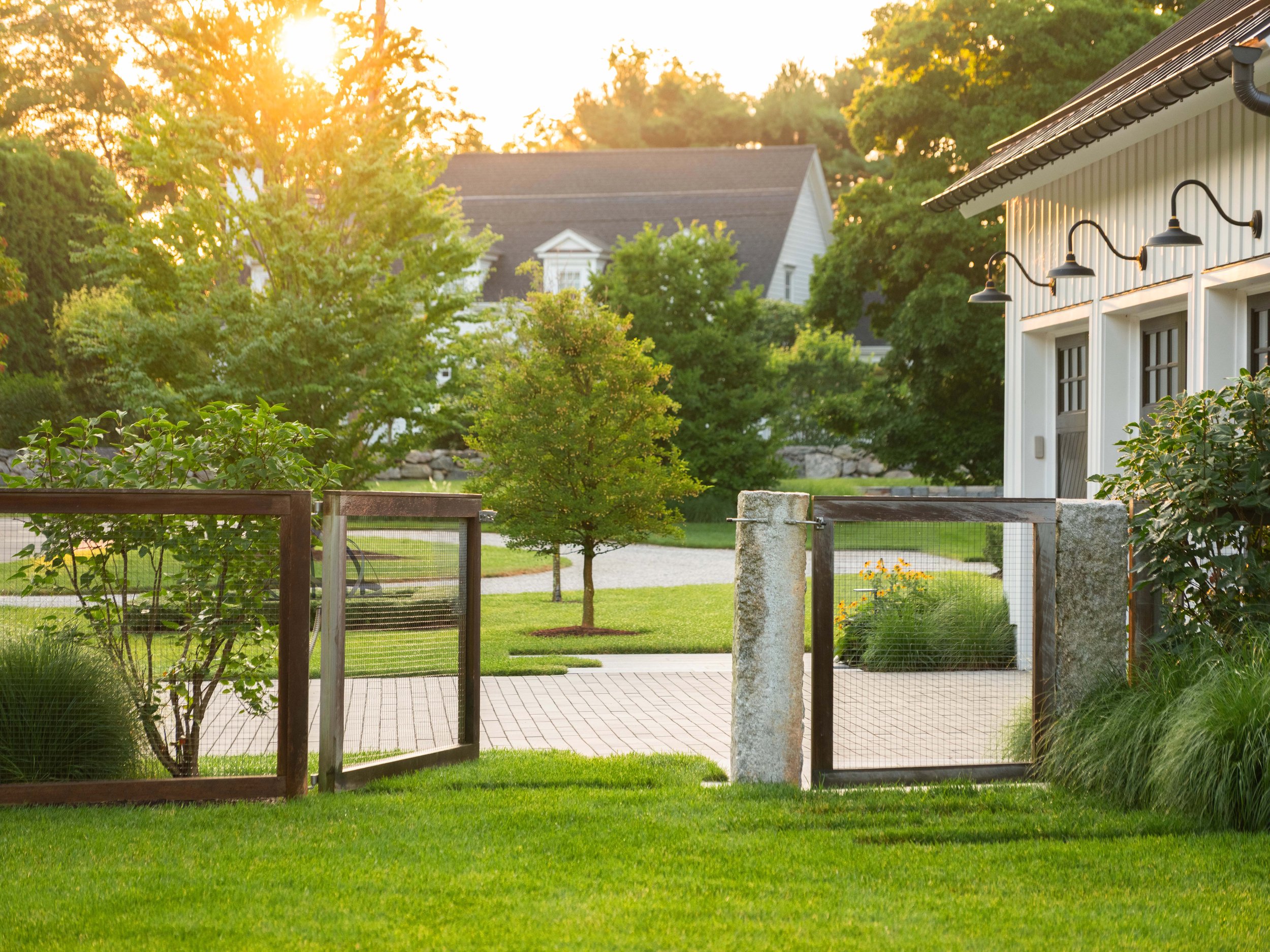 Wood framed mesh gates with monolithic stone posts