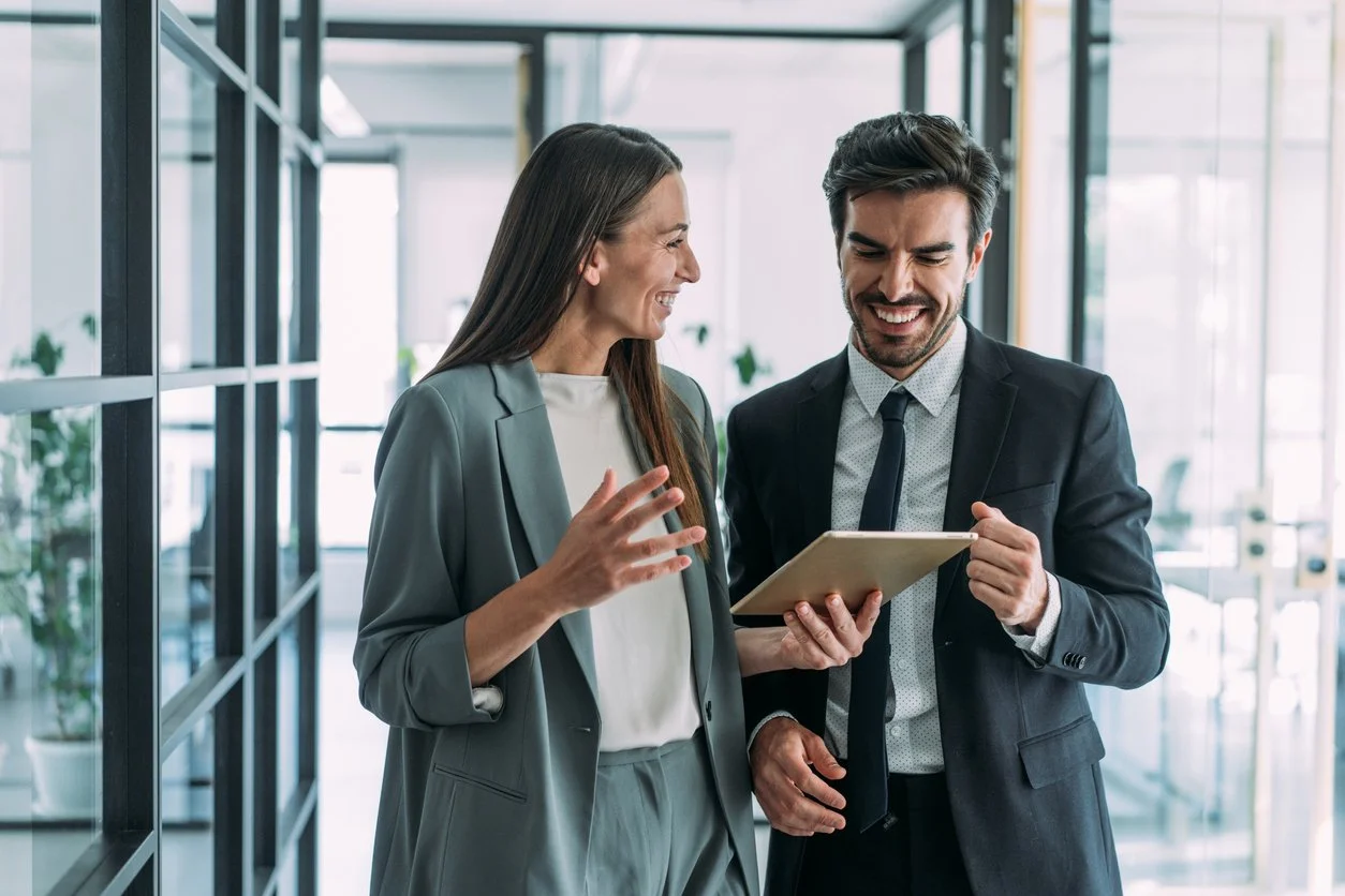 two coworkers having a discussion in modern office