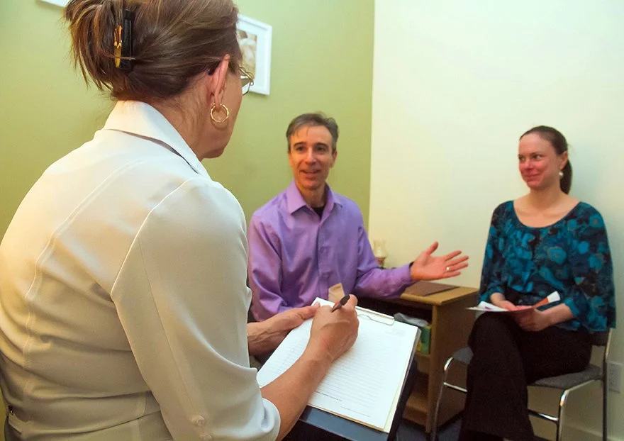 Laser Therapist conducting an in-clinic consultation with clients