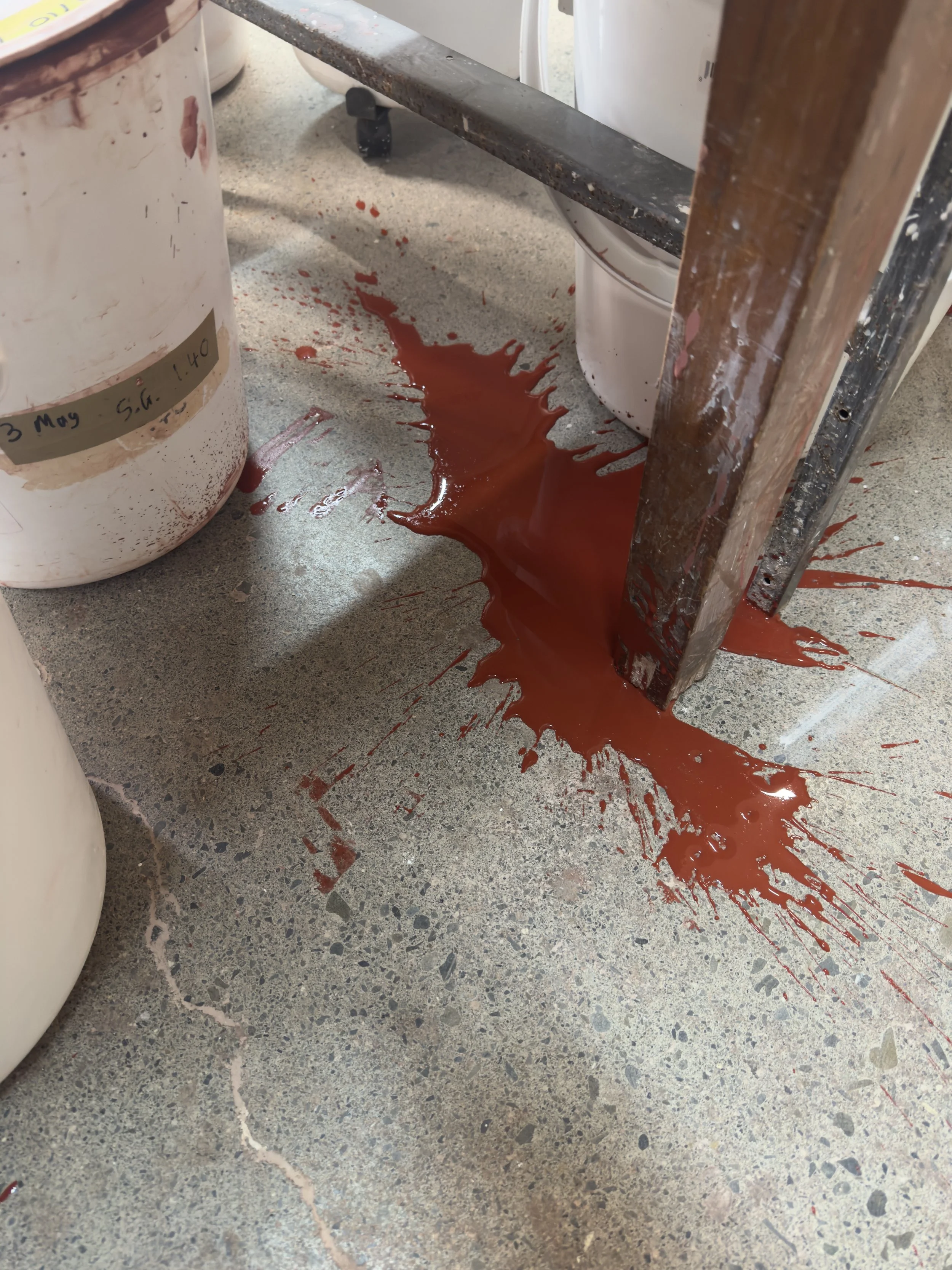 Tenmoku glaze was spilled on the floor and left uncleaned.