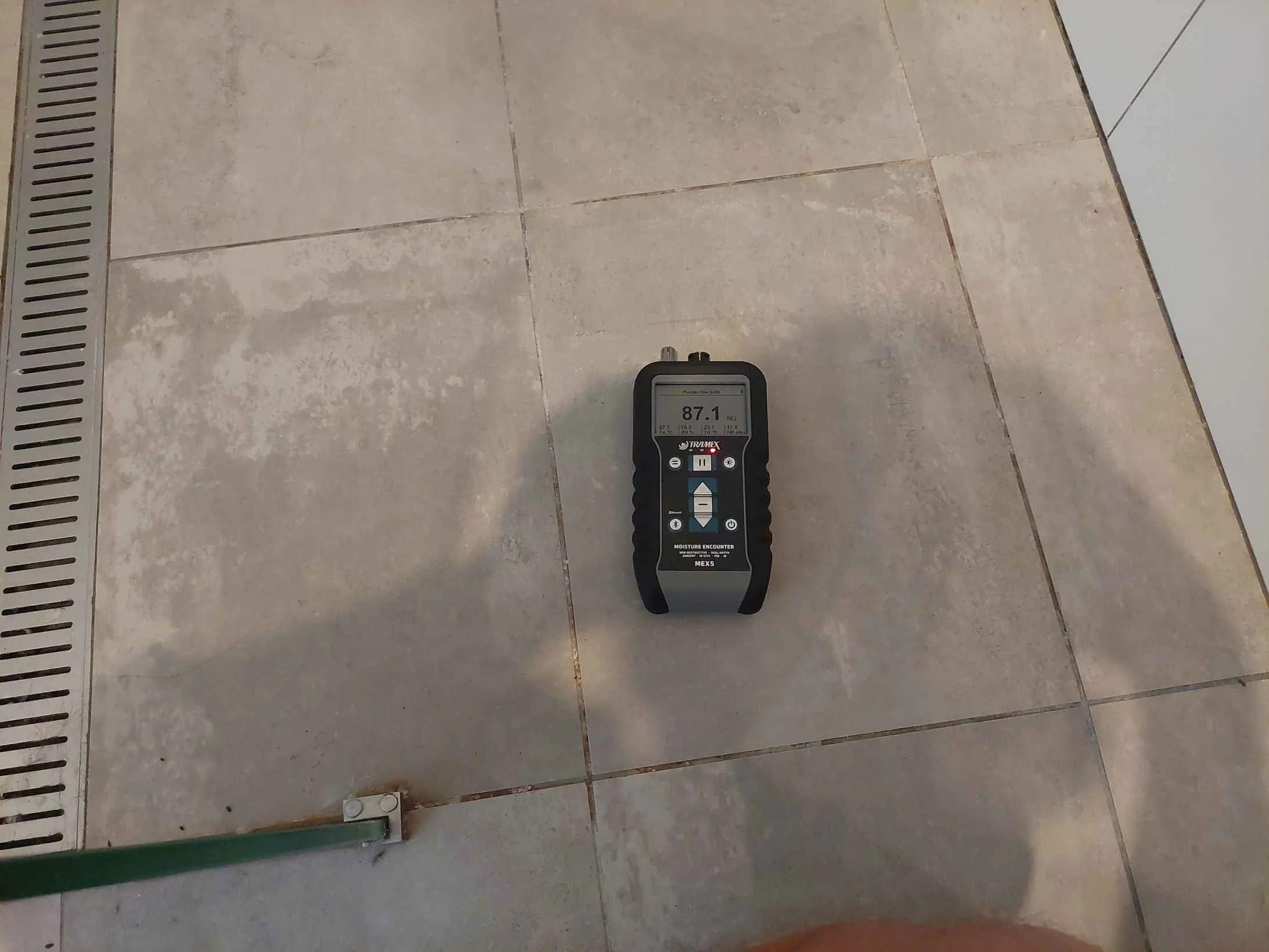 Elevated moisture levels detected within shower area, indicating potential water ingress or waterproofing failure.