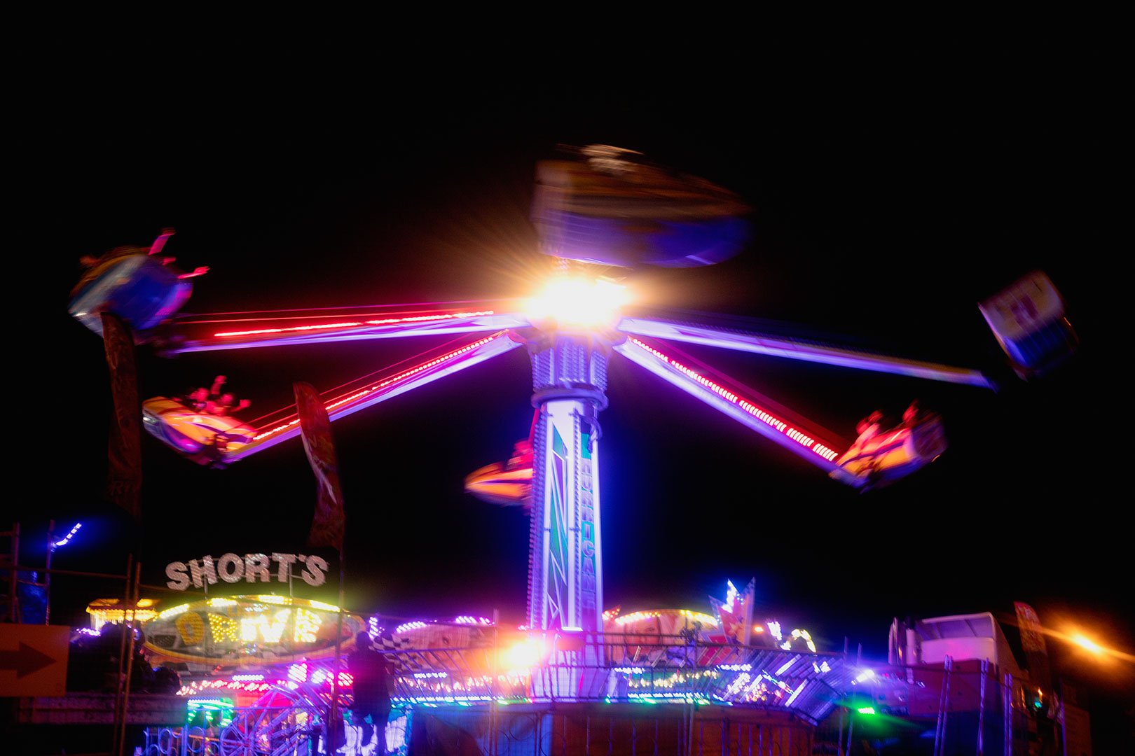 A fair ride spinning at night.