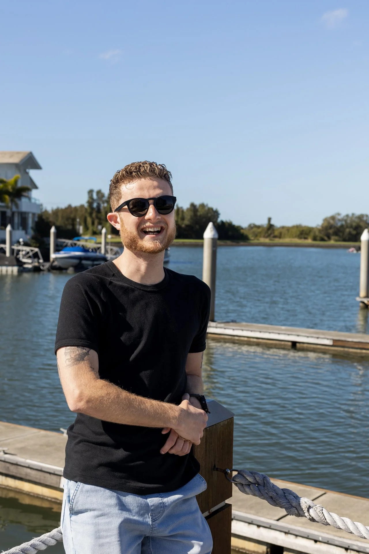 Man standing confidently by Coomera Waters boardwalk for personal branding.