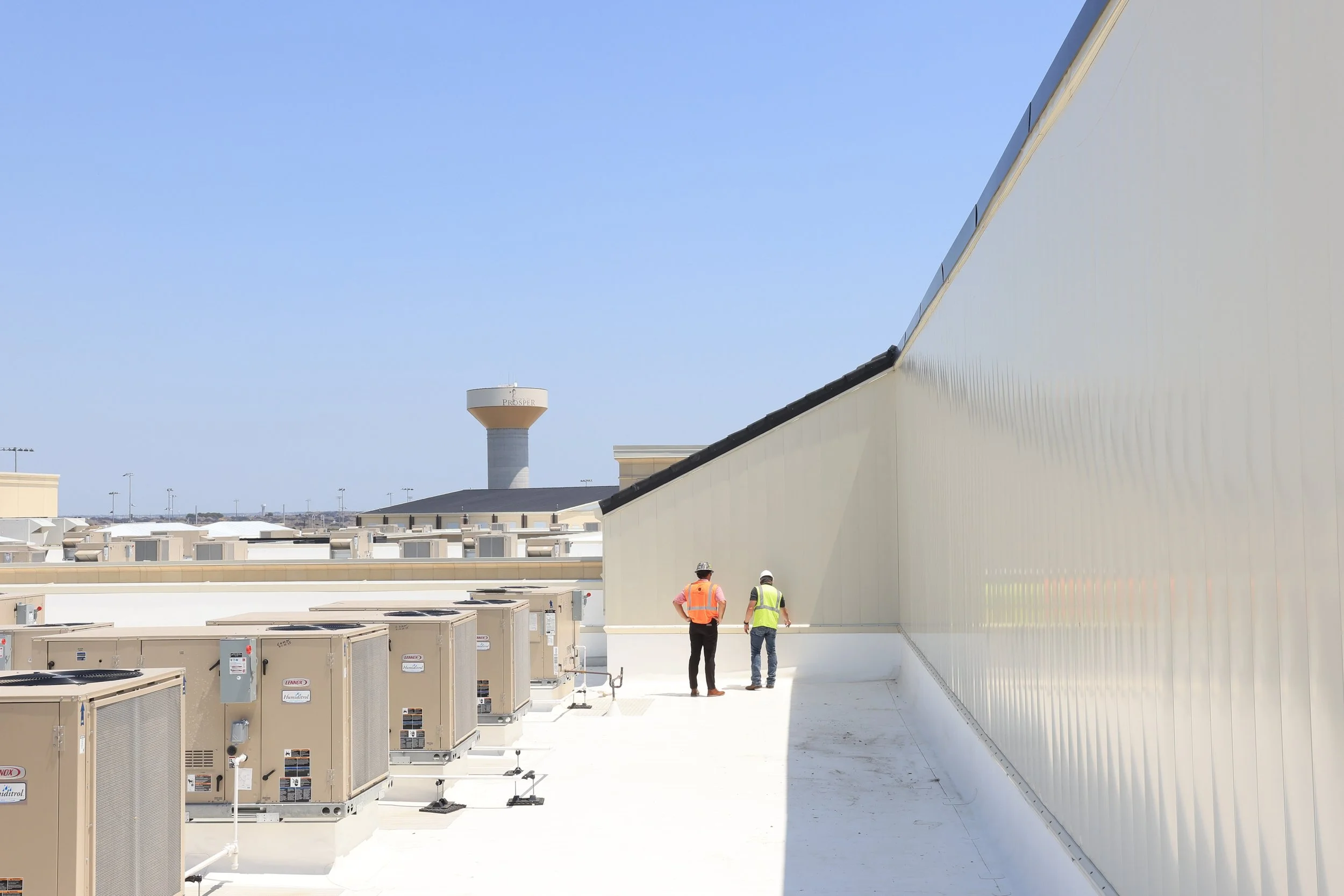 red outter building glass and blue sky. IB Roofing and PAC-CLAD material.