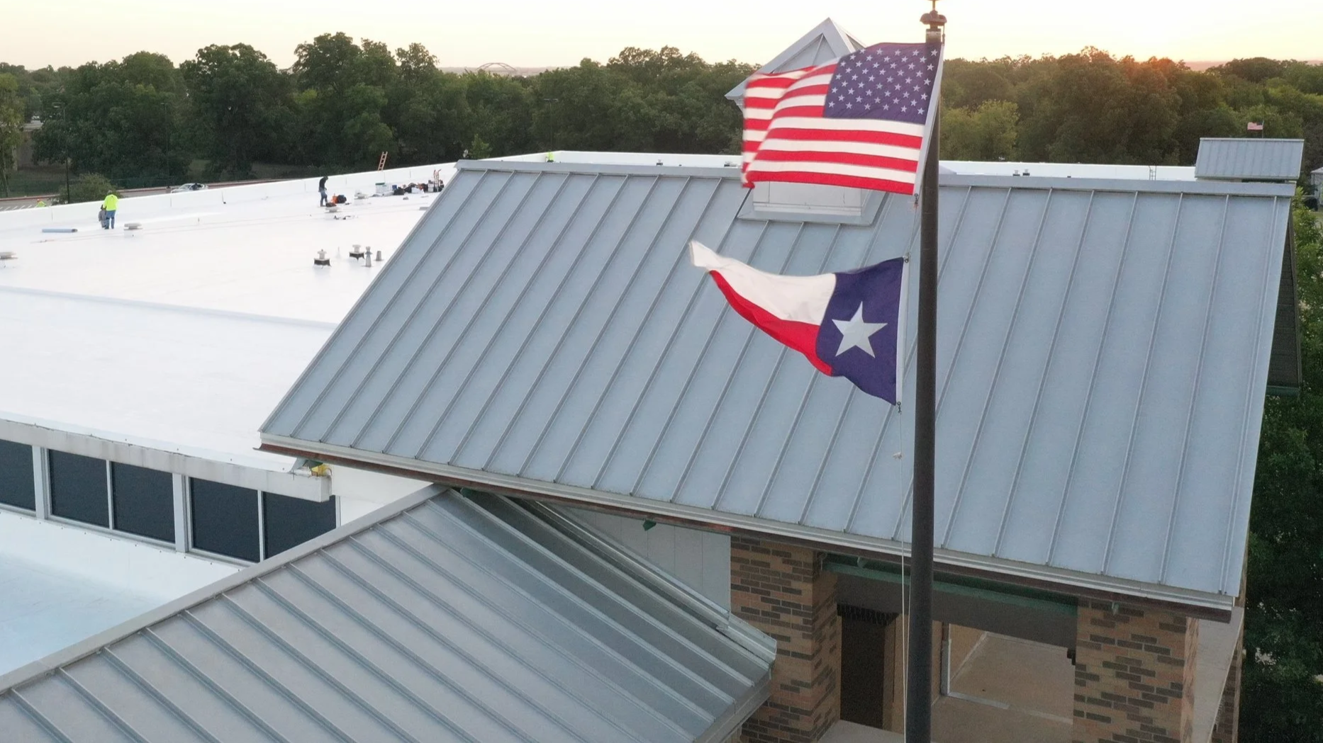 Top of a meatl roof with white brick and blue glass outer design.