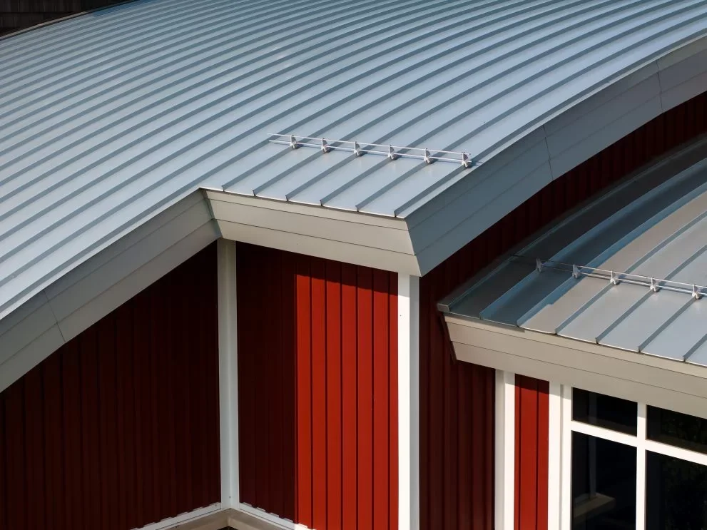 red outter building glass and blue sky. IB Roofing and PAC-CLAD material.