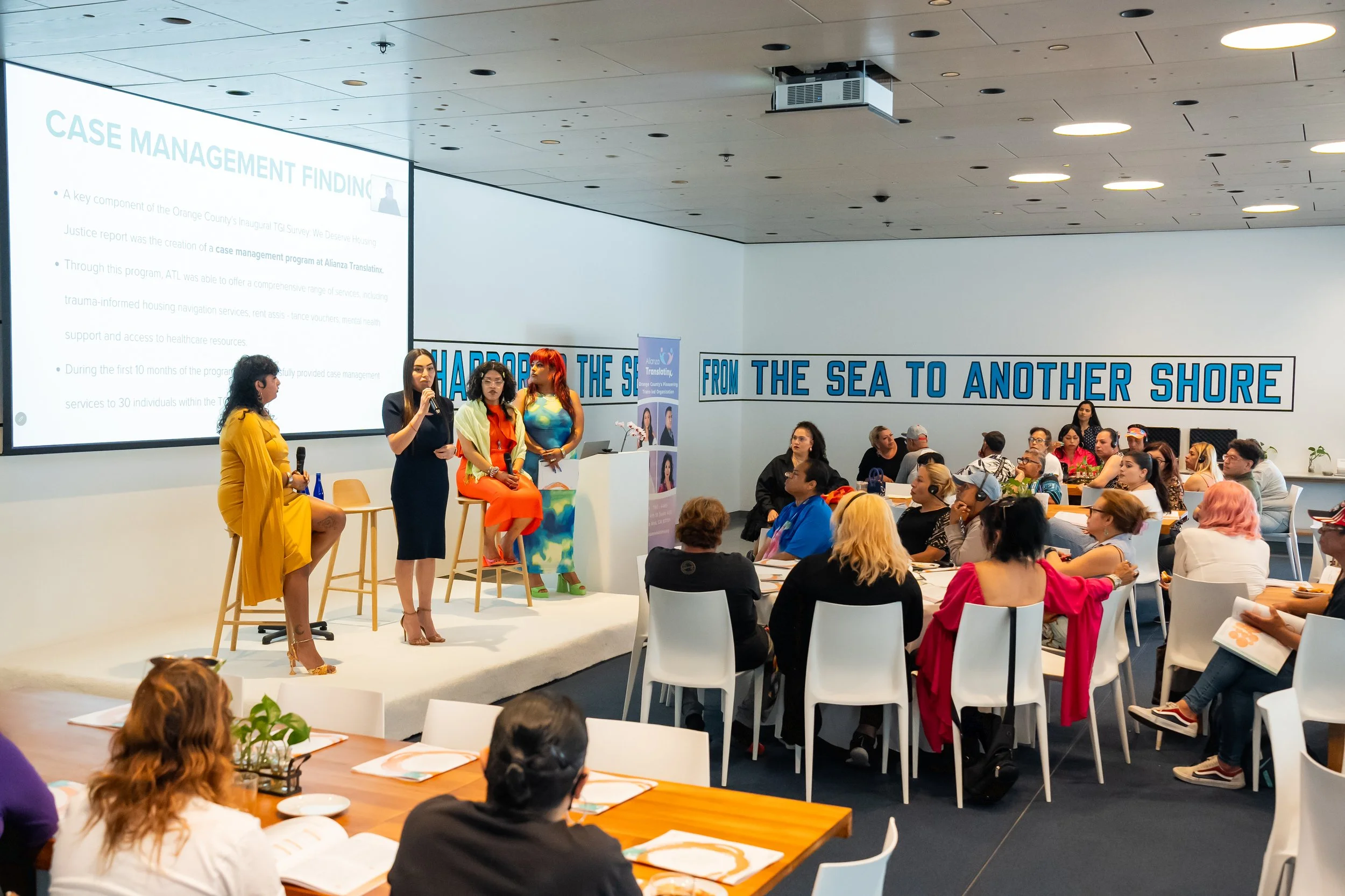 Audience members listen to panel discussion about the results of the trans housing survey