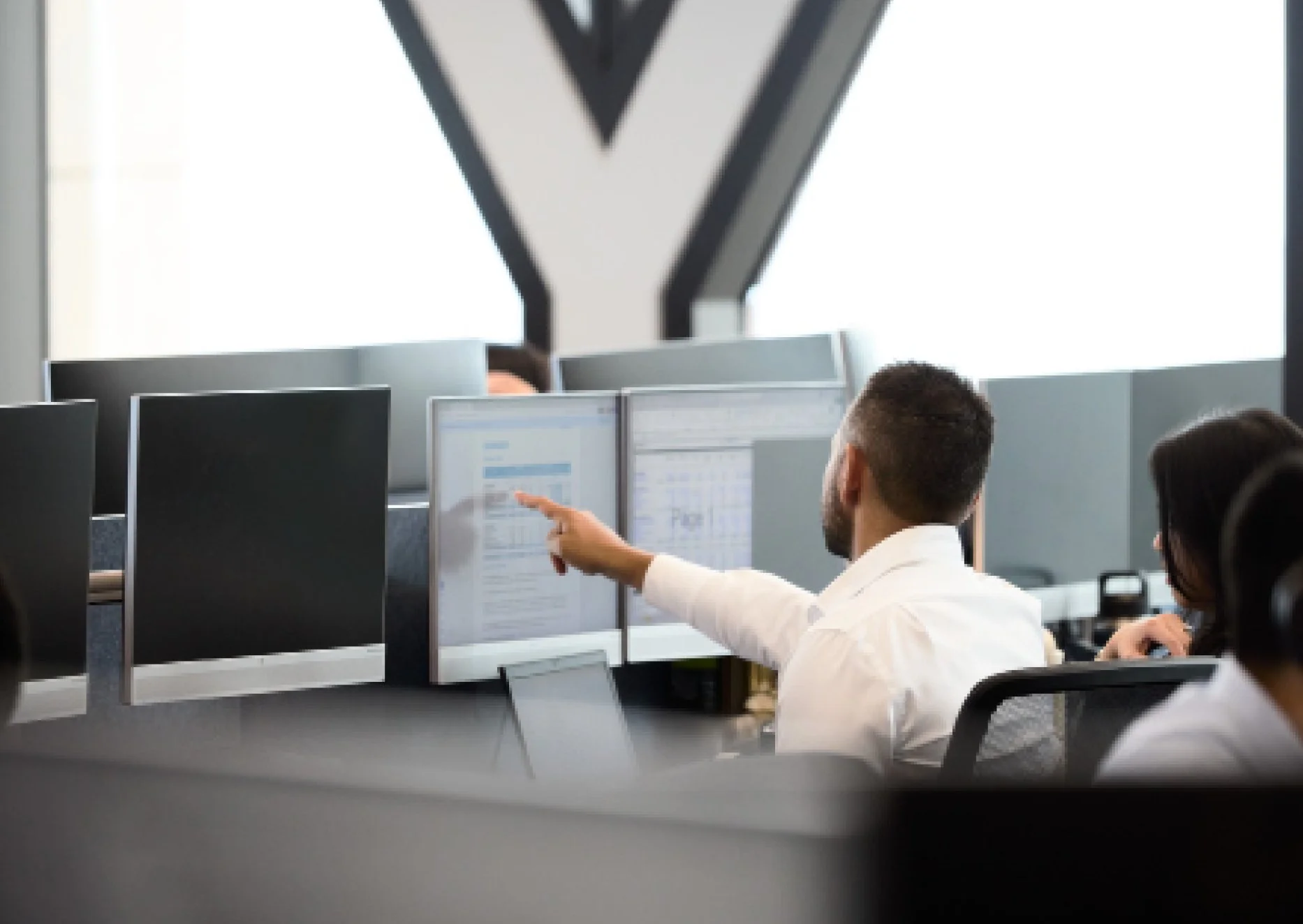 Man pointing to work computer monitor