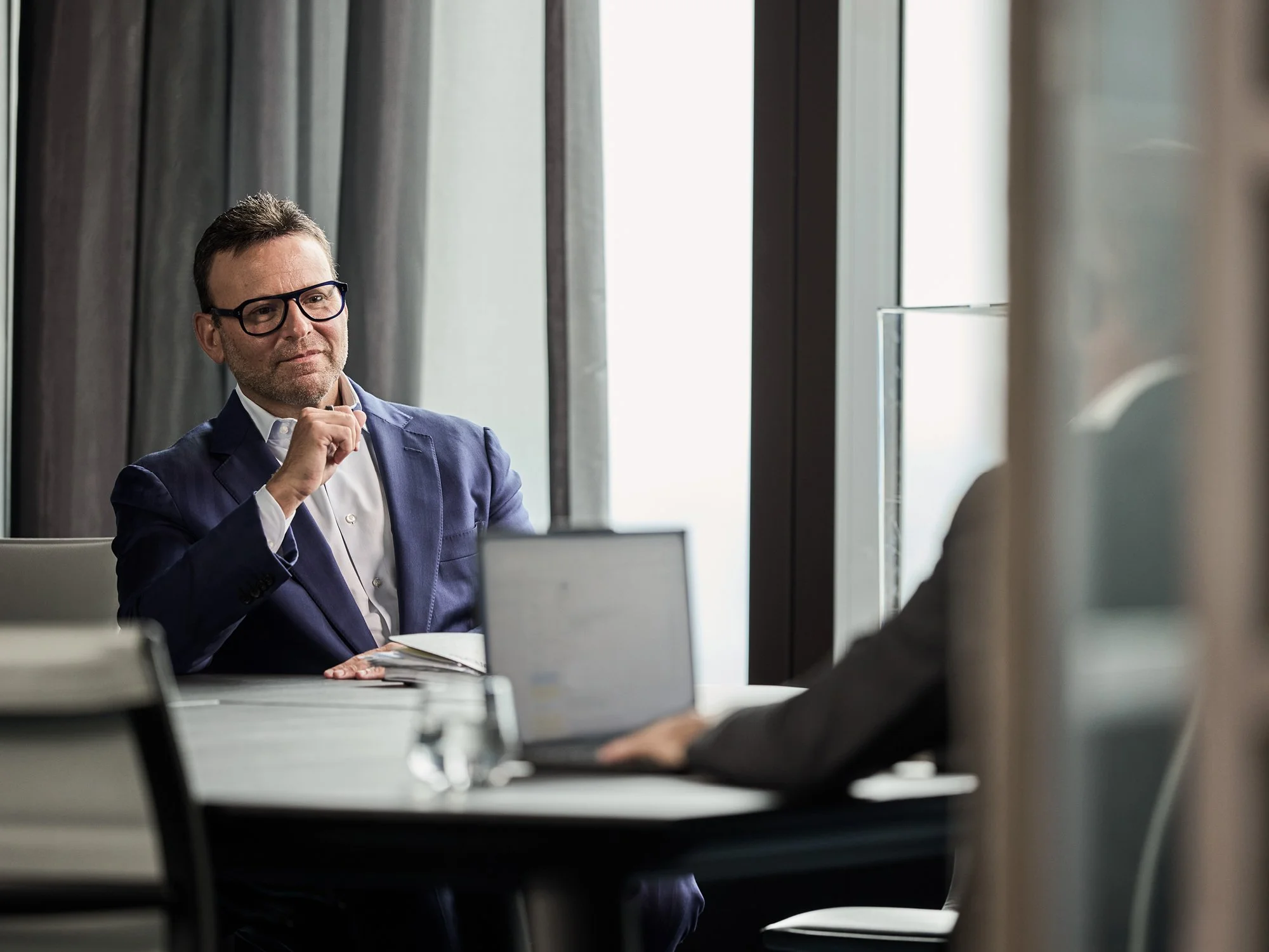 Image of two men sitting at work