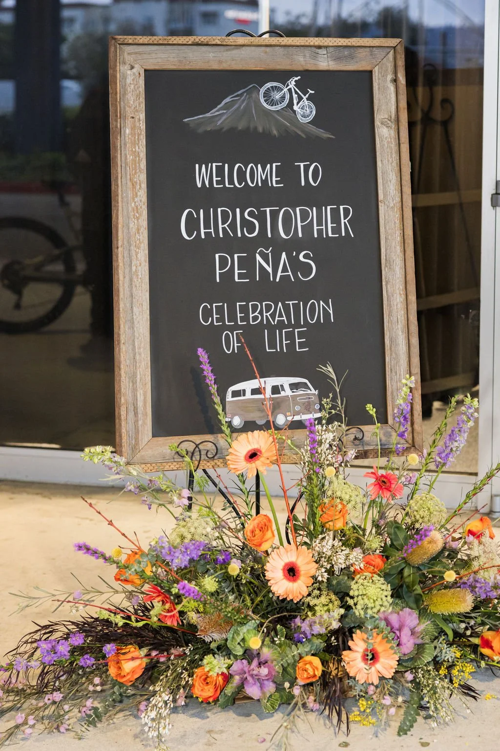 celebration of life welcome sign with flowers