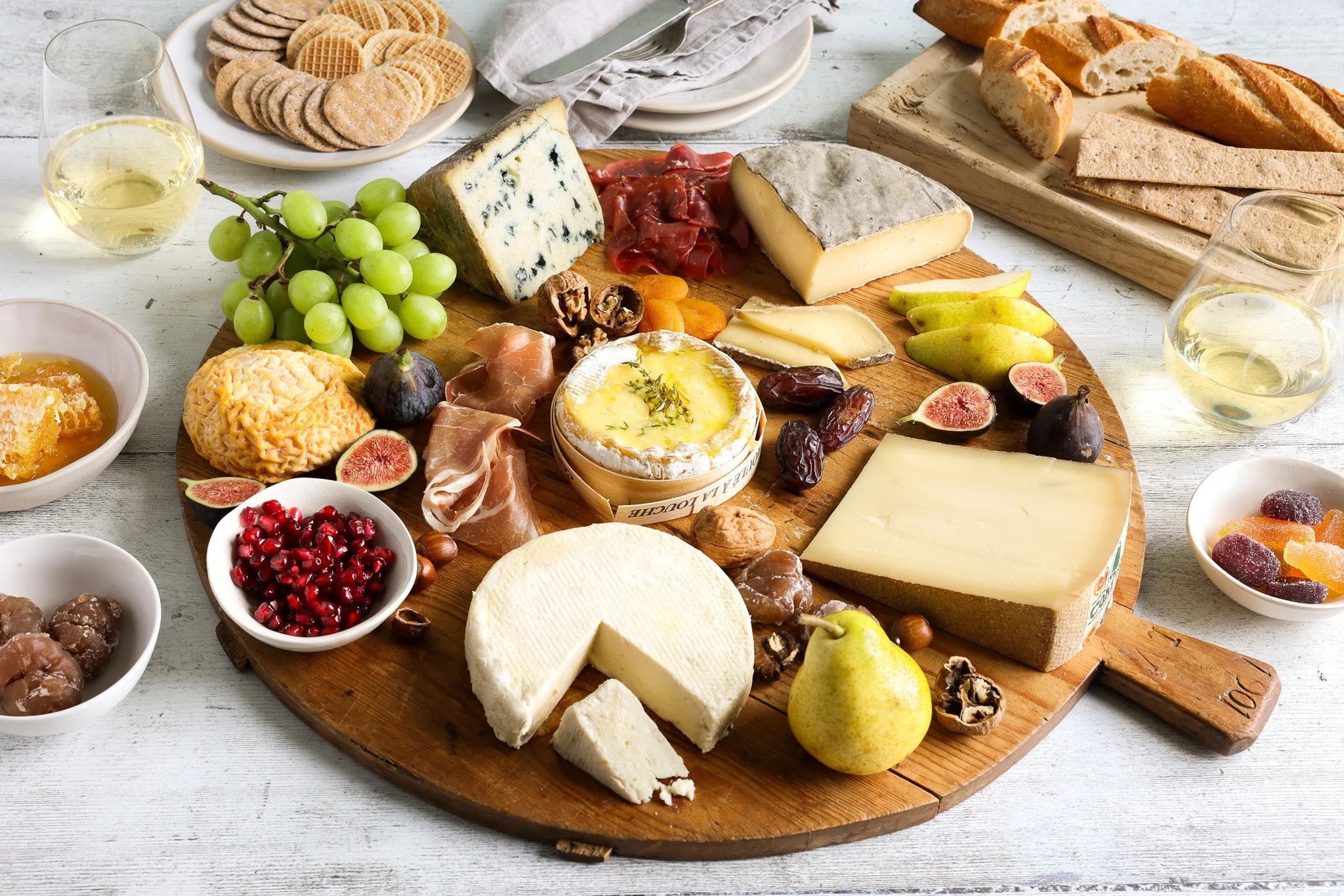 A platter of French cheeses with grapes, nuts and fruit, styled and photographed for the French Cheese Board 