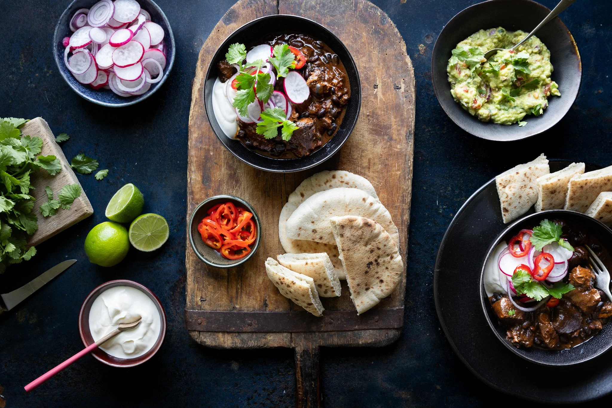Bowls of chilli, guacamole and radishes photographed for UK food brand Mamoosh