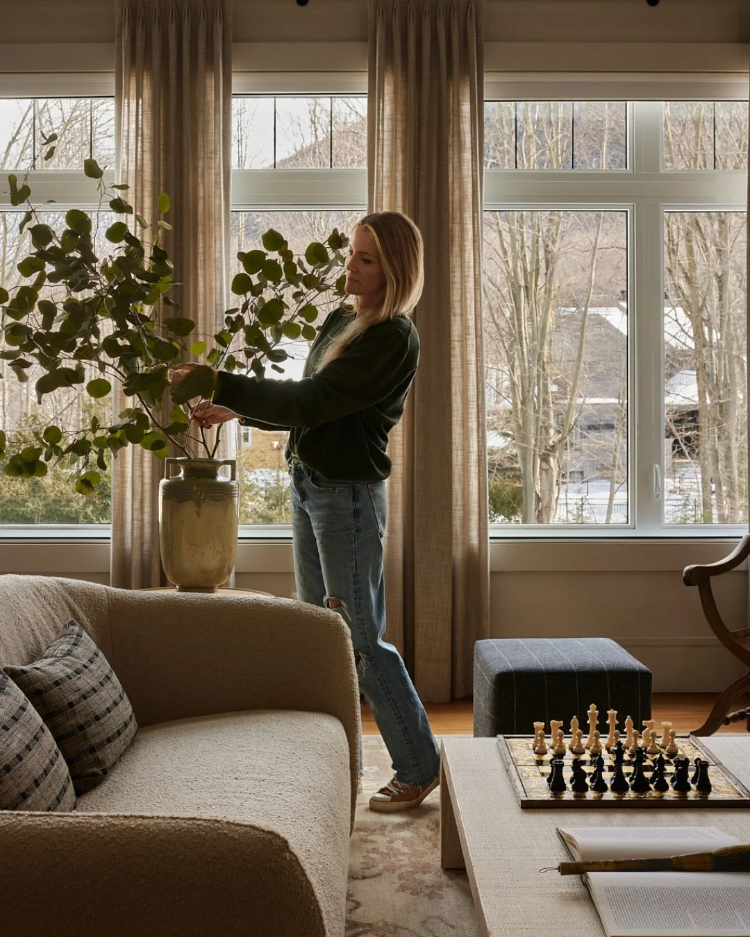 Home styling moment by Blanc Marine Interiors with large windows, soft drapery, and neutral decor