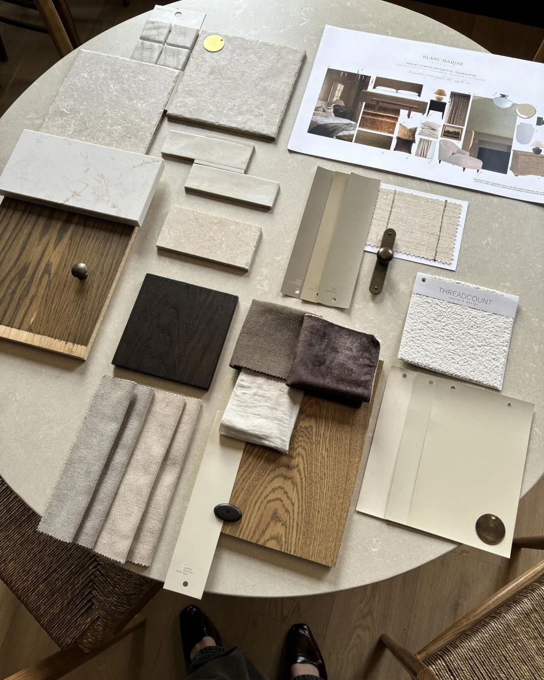 Material board for a bathroom design by Blanc Marine Interiors with marble, brass and natural textures”