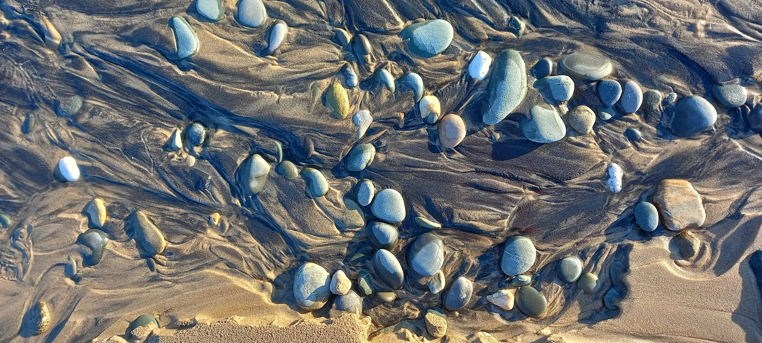 Where a small stream meets the sea early in the morning