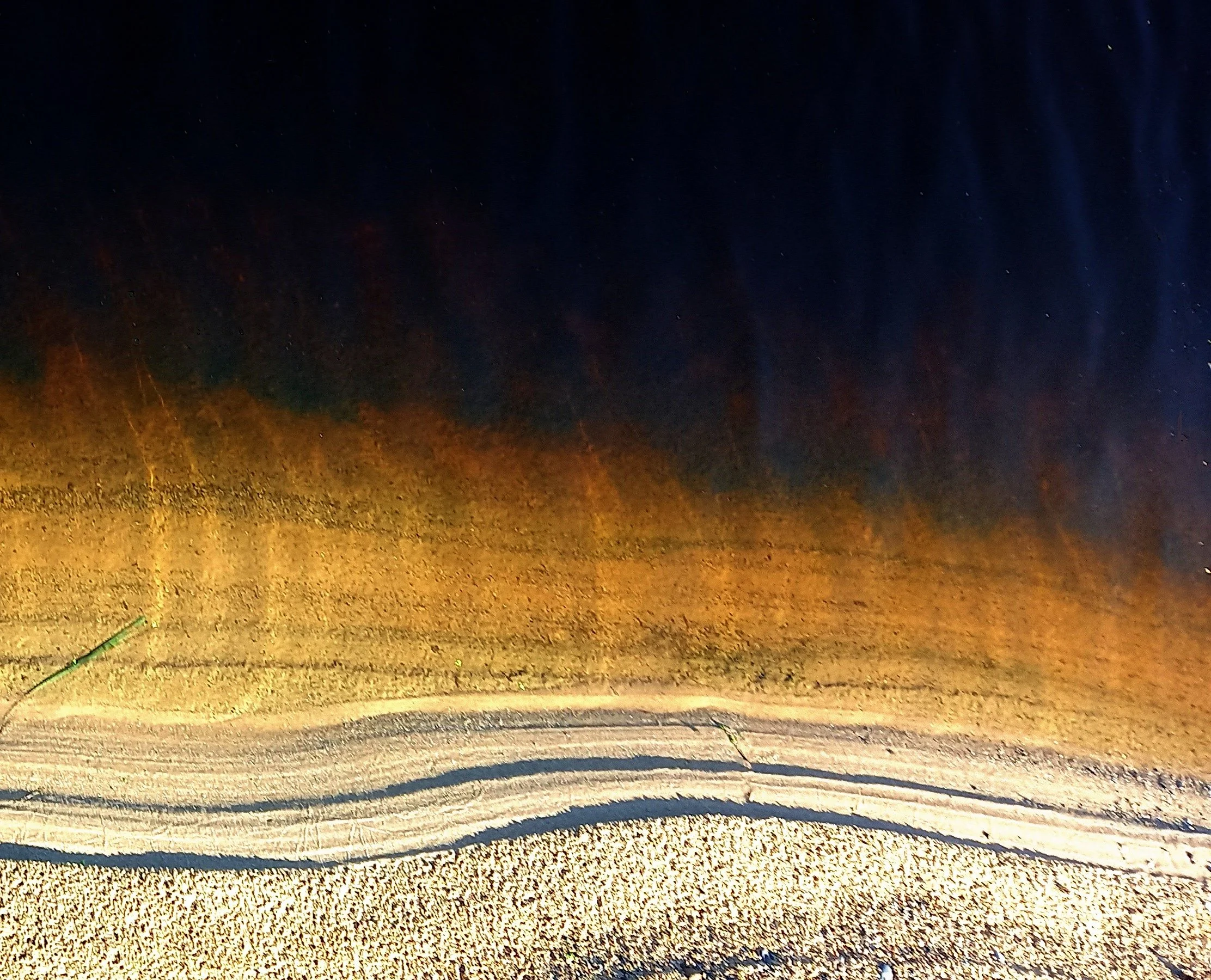 Water's edge at dark river lagoon near Clones beach, Co. Wexford