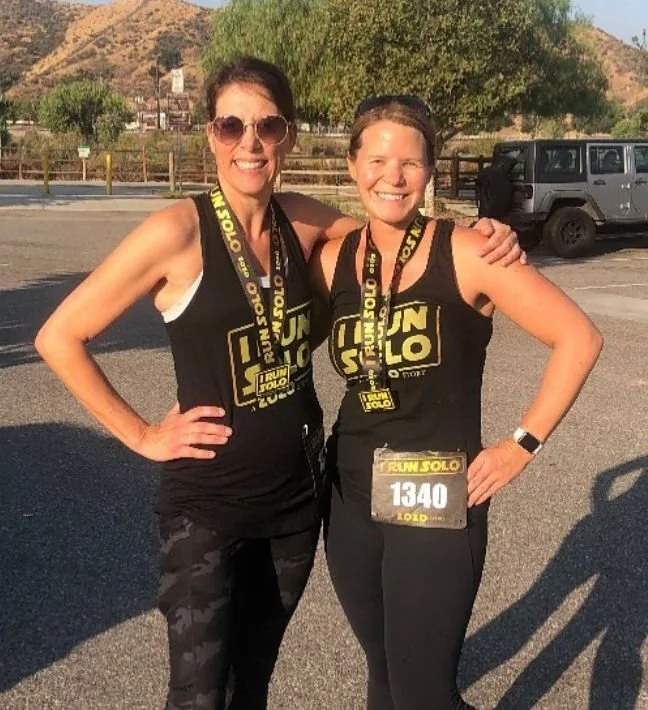Tracy Souza and a friend pose for a photo after the "I run solo" race.