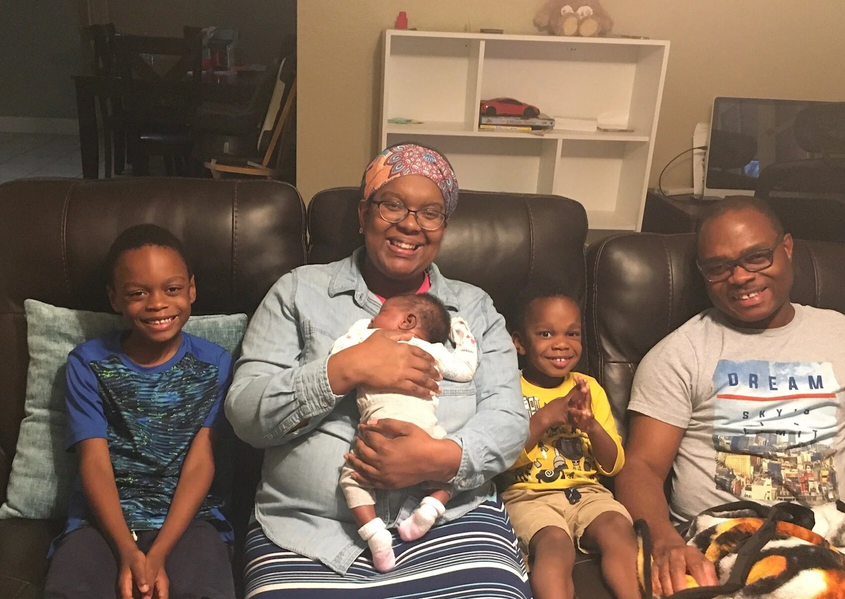 Richmond Appleton is pictured with his wife and three children in their home.