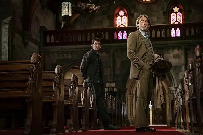 Young priest Jud Duplenticy (Josh O'Connor) and atheist detective Benoit Blanc (Daniel Craig) in Wake Up Dead Man: A Knives Out Mystery (Netflix, 2025).