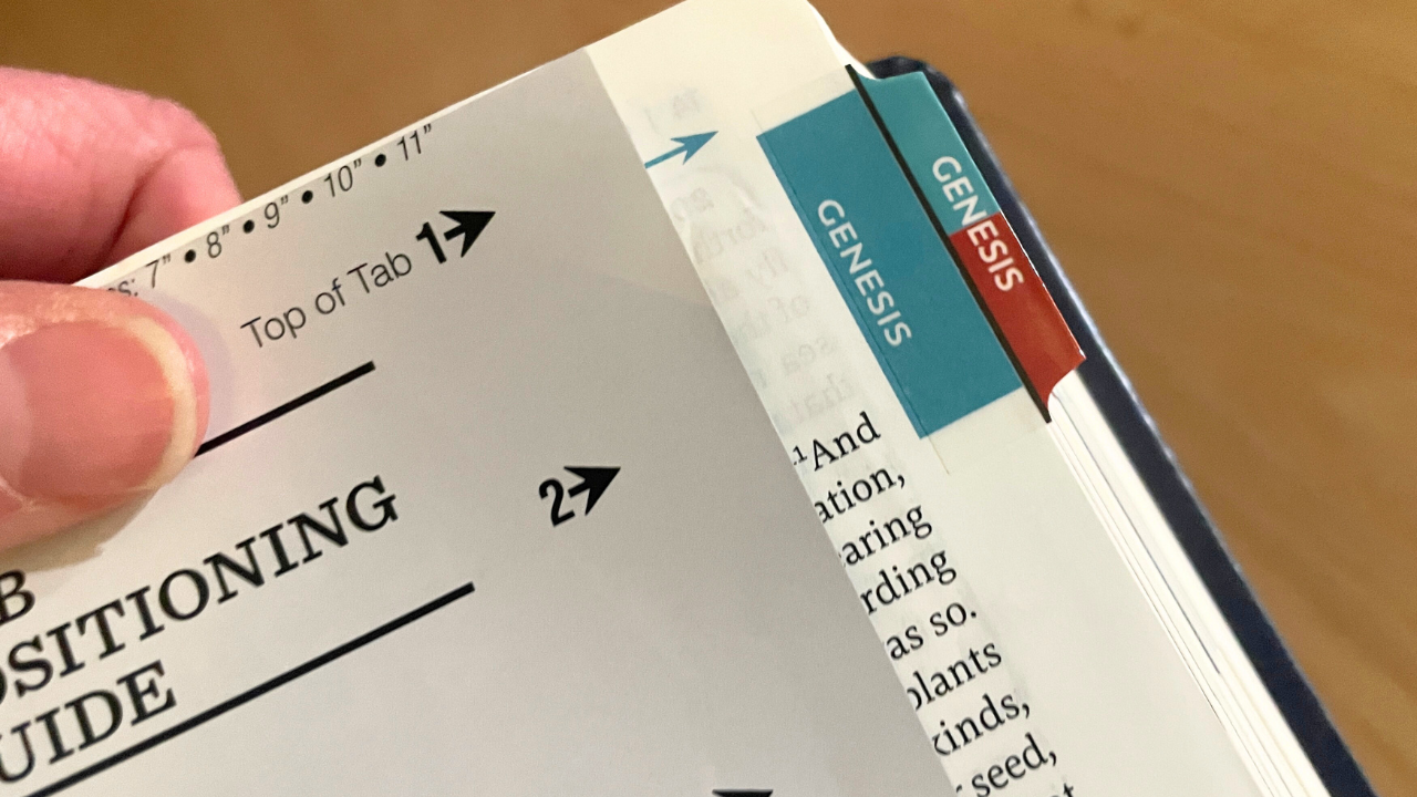 Step 1: Line up the positioning guide that came with your Bible. You'll place the top of your Bible tab with the arrow.