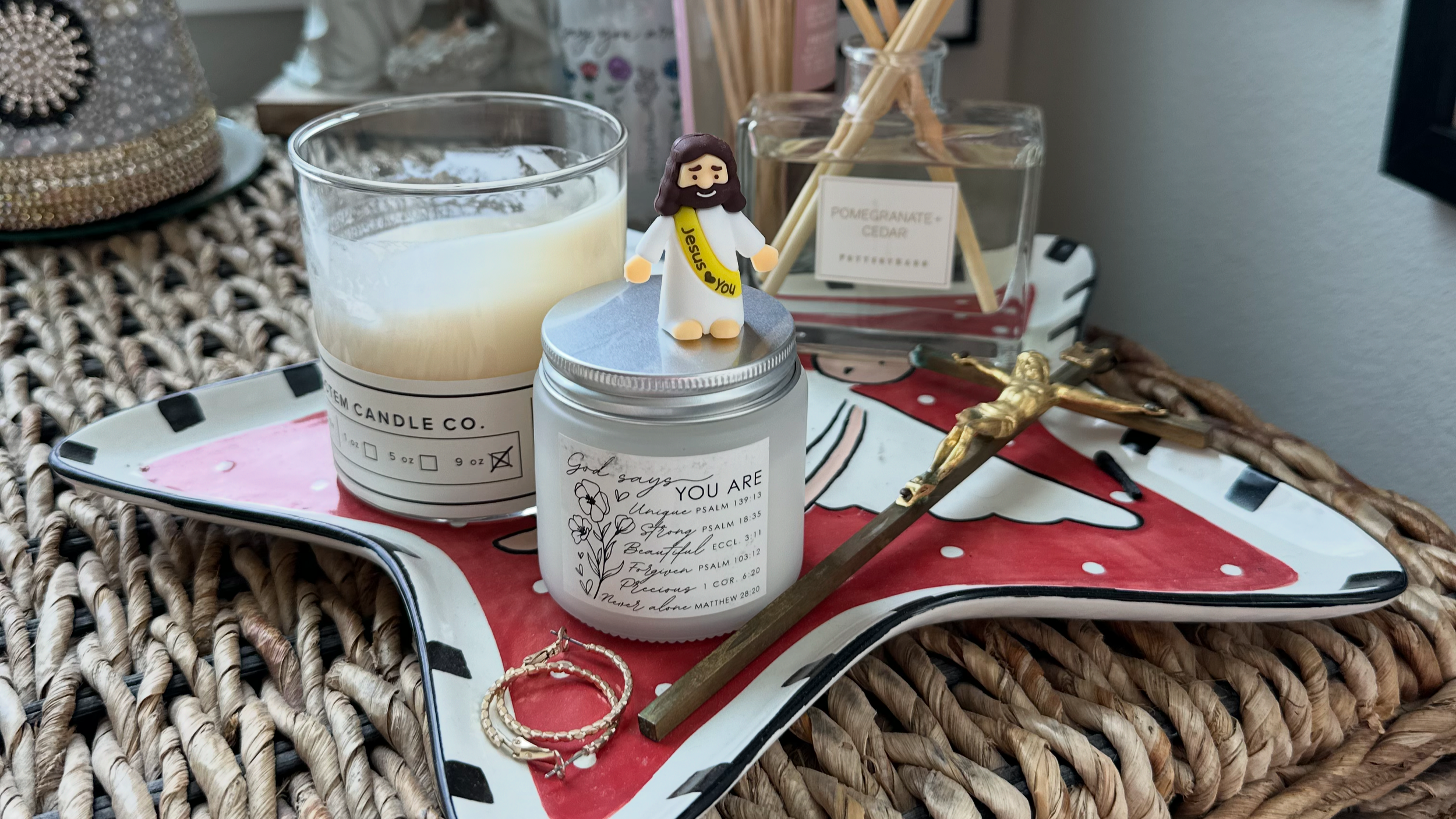 A friend found a mini Jesus figure and loved it so much she decided to take it home. She placed the figurine on a candle on her dresser next to  her earings, a Jesus crucifixion, and other meaningful items.