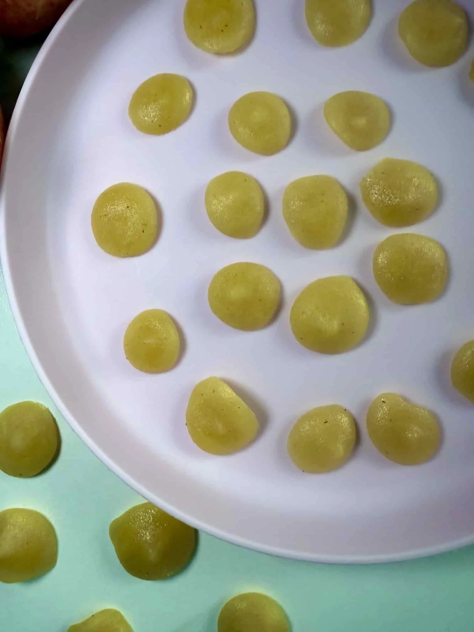 Several bite sized portions of applesauce on serving dish ready for the freezer