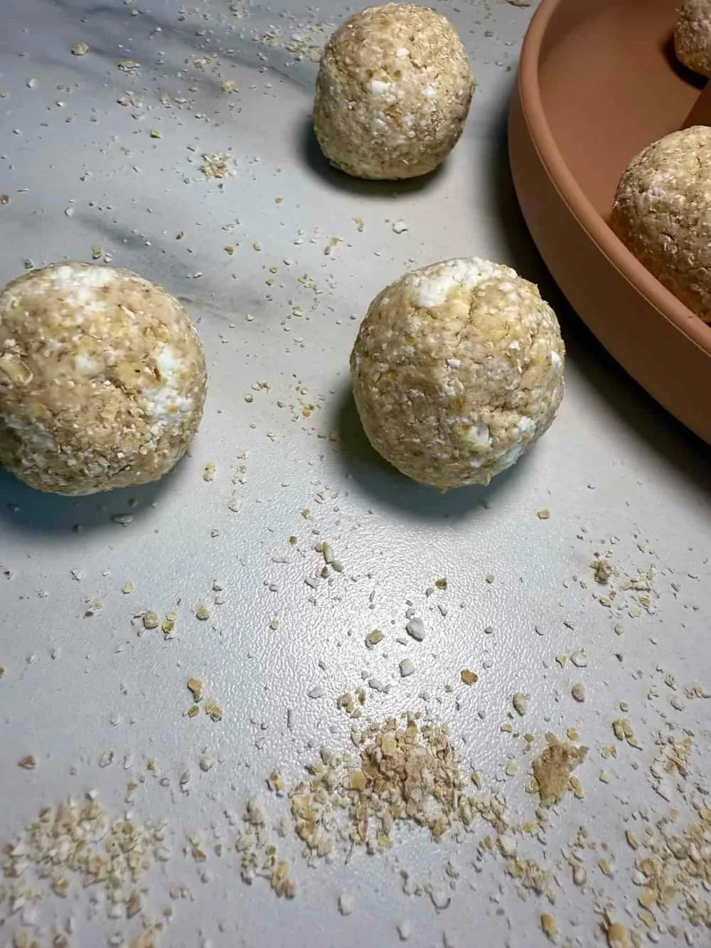 Several cottage cheese and oat balls served on a toddler plate