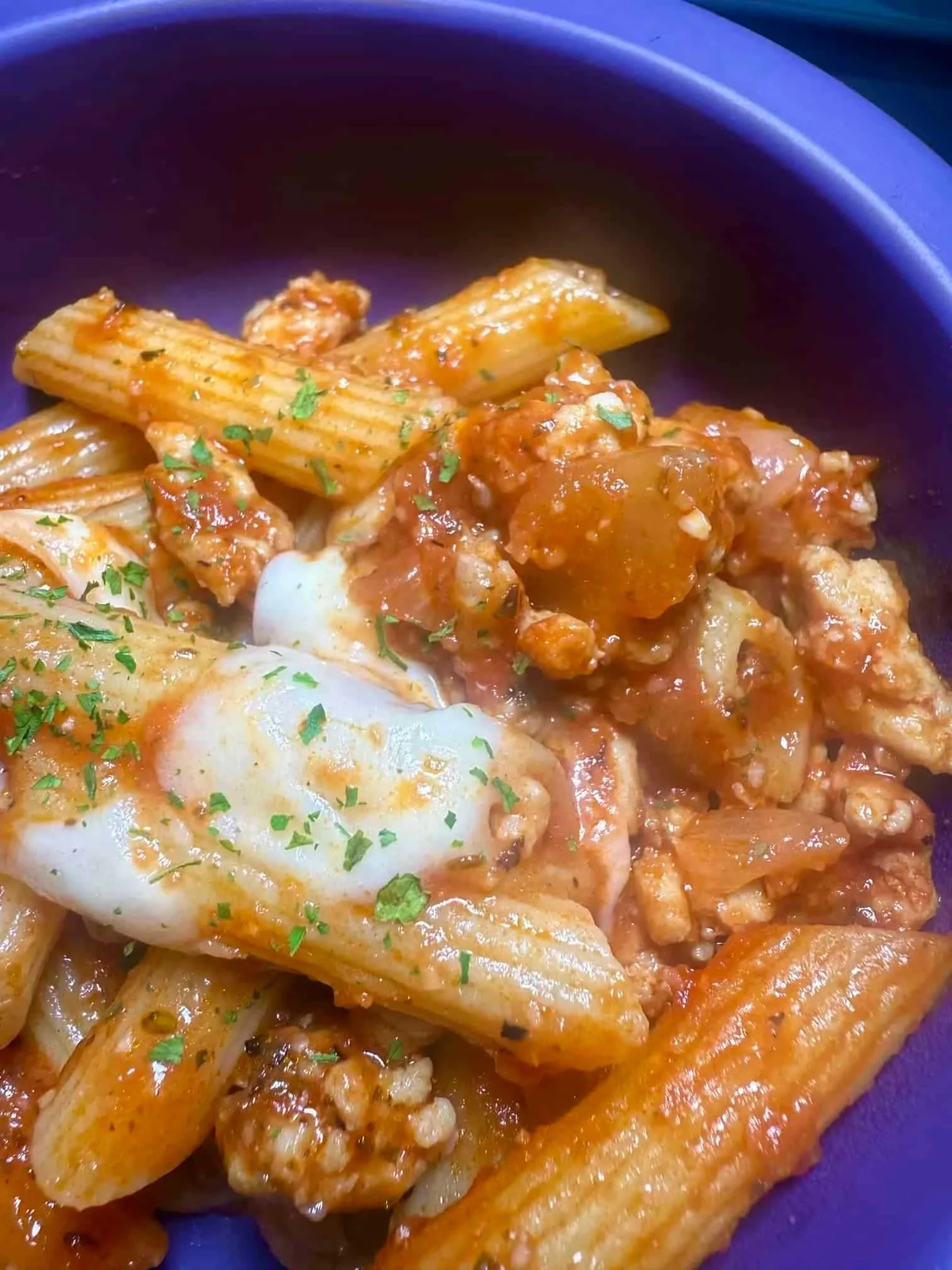 A portion of chicken mince pasta served in a toddler dish
