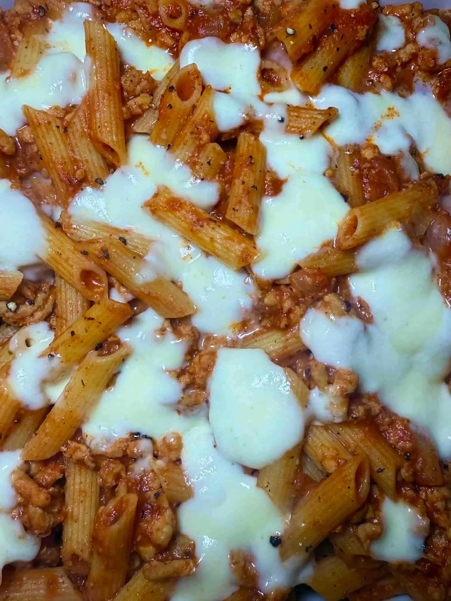 A portion of chicken mince penne pasta served in a toddler dish