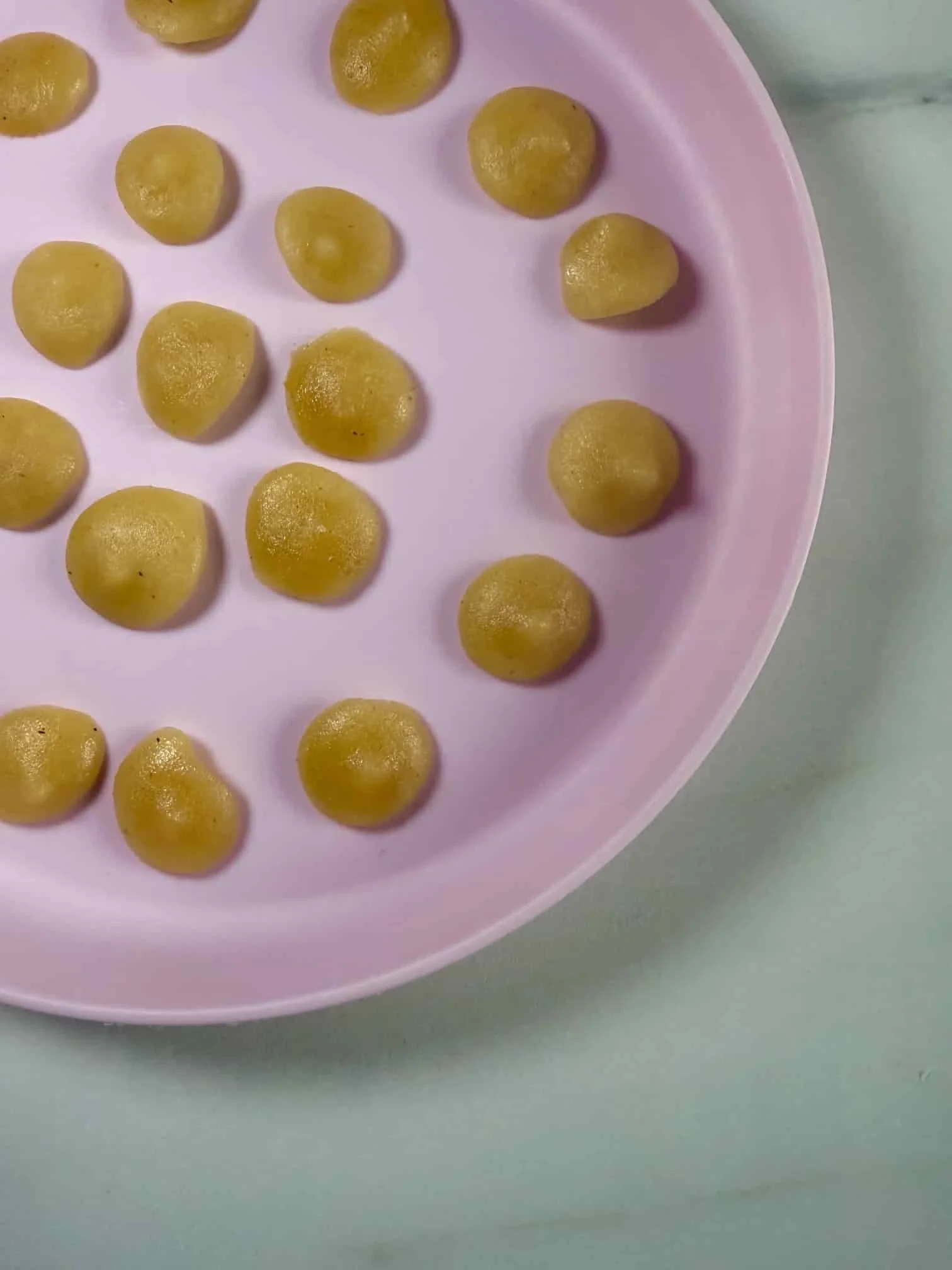 Several bite sized portions of applesauce on serving dish ready for the freezer