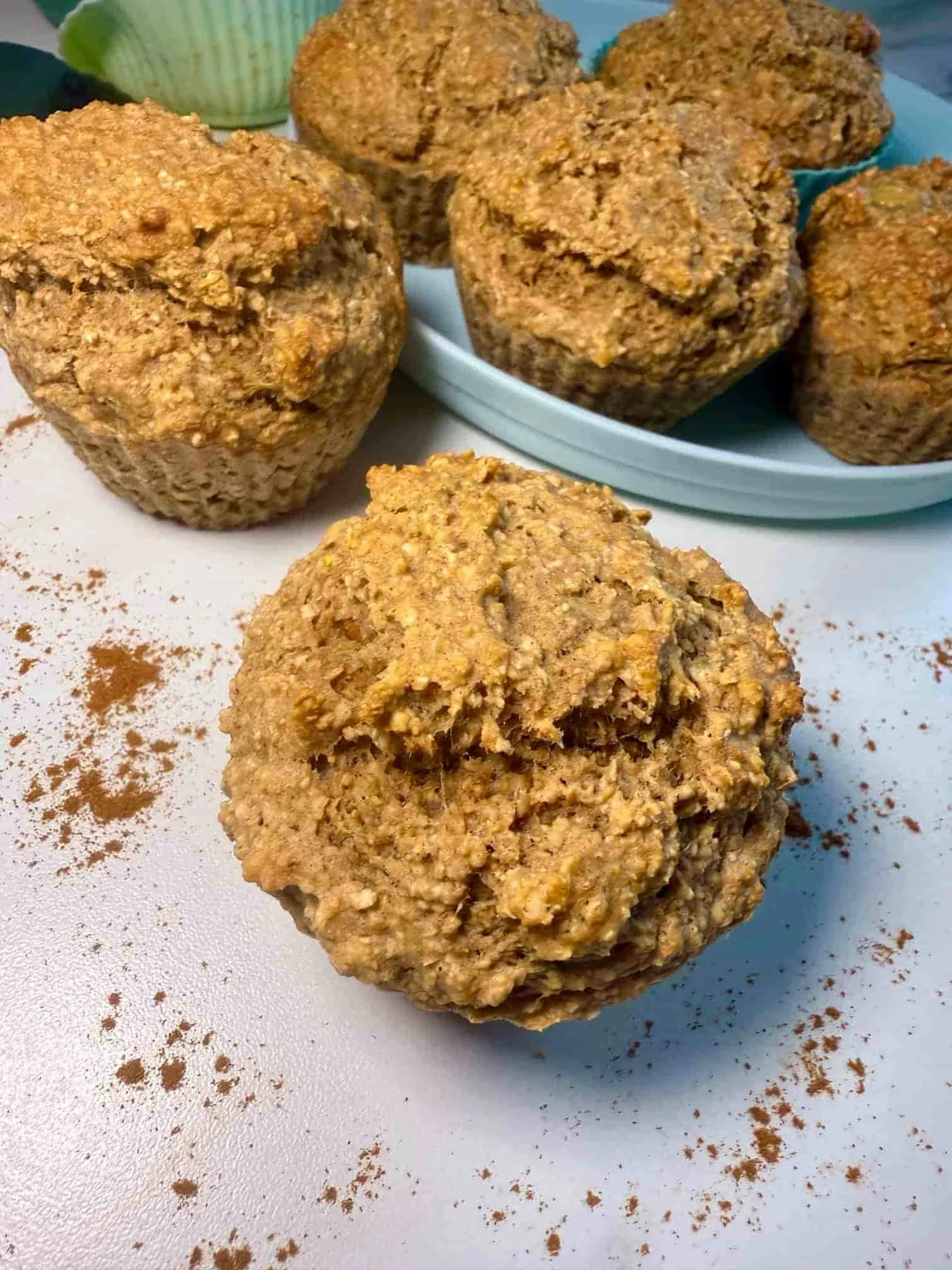 Several banana lentil muffins on serving board and toddler plate