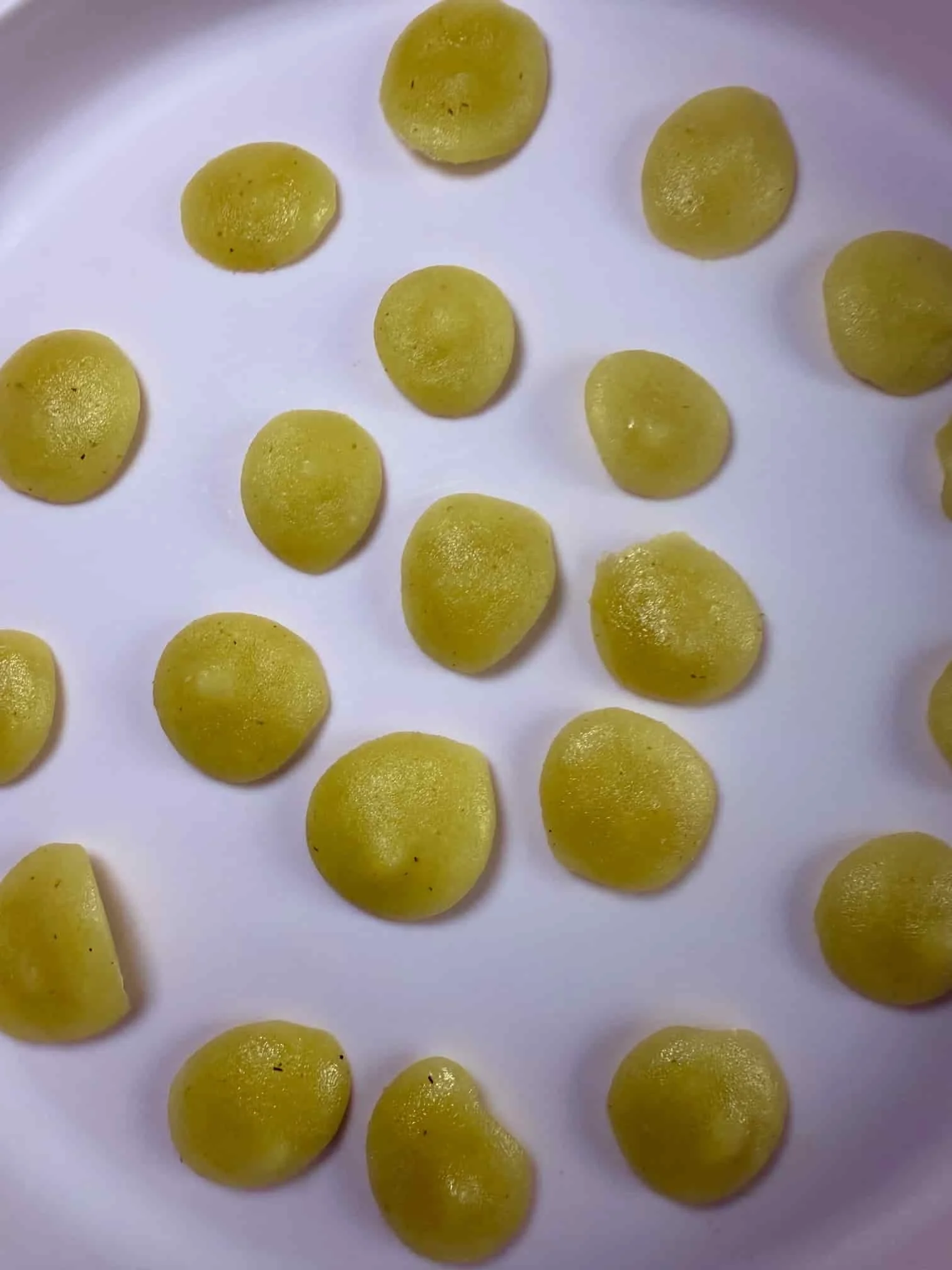 Several bite sized portions of applesauce on serving dish ready for the freezer