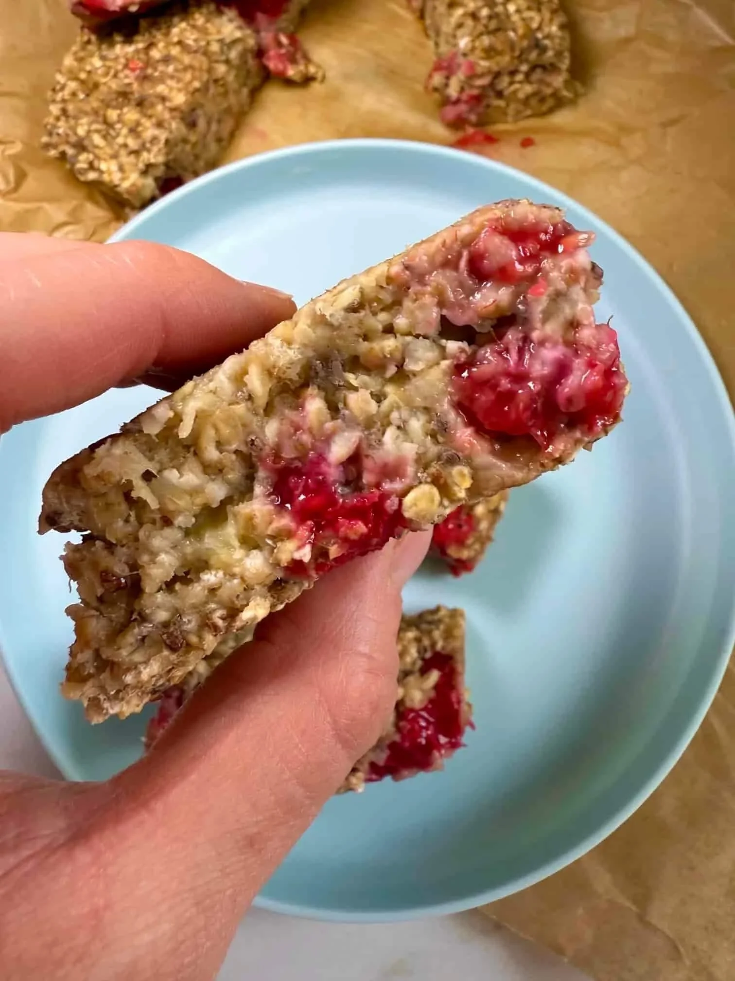 Close up image someone holding a baked porridge finger