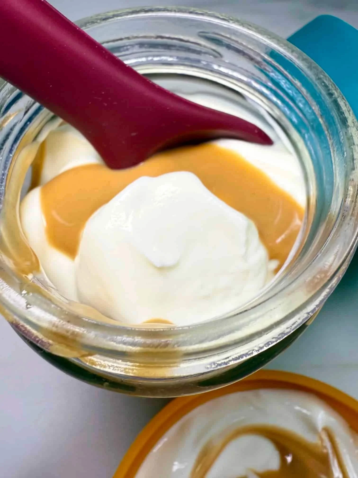 Greek yogurt swirled with peanut butter and served in a glass pot with a silicone lid