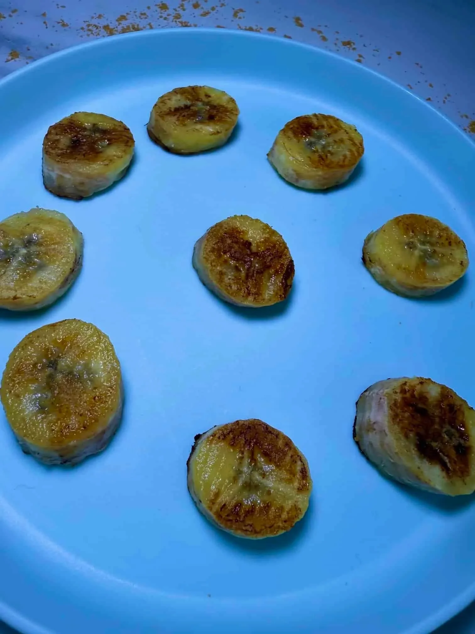 Slices of caramelized pan fried bananas served on toddler plate