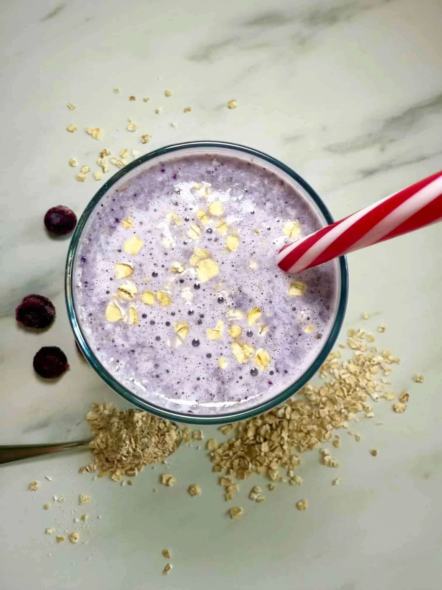A glass of the lactation smoothie with blueberries and oats
