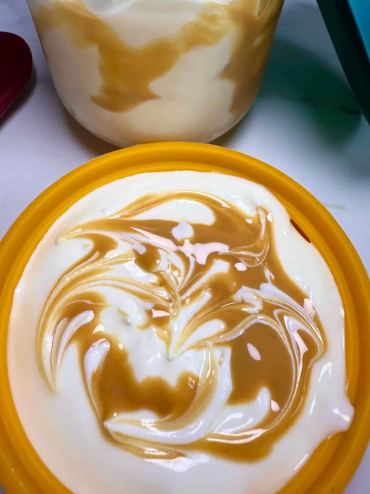 Greek yogurt swirled with peanut butter and served in a glass pot with a silicone lid