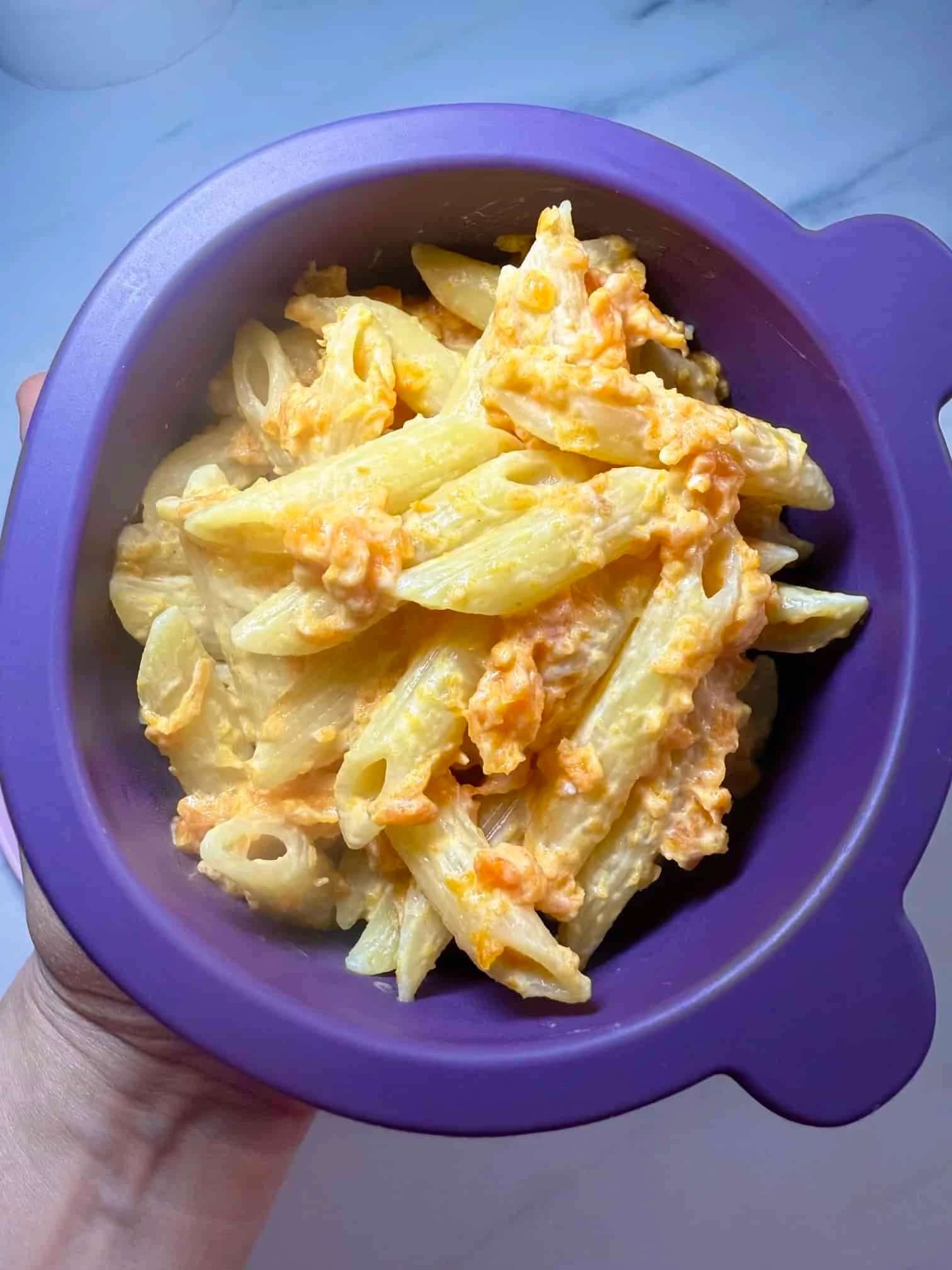 A toddler portion of pasta served with a creamy kid-friendly carrot pasta sauce