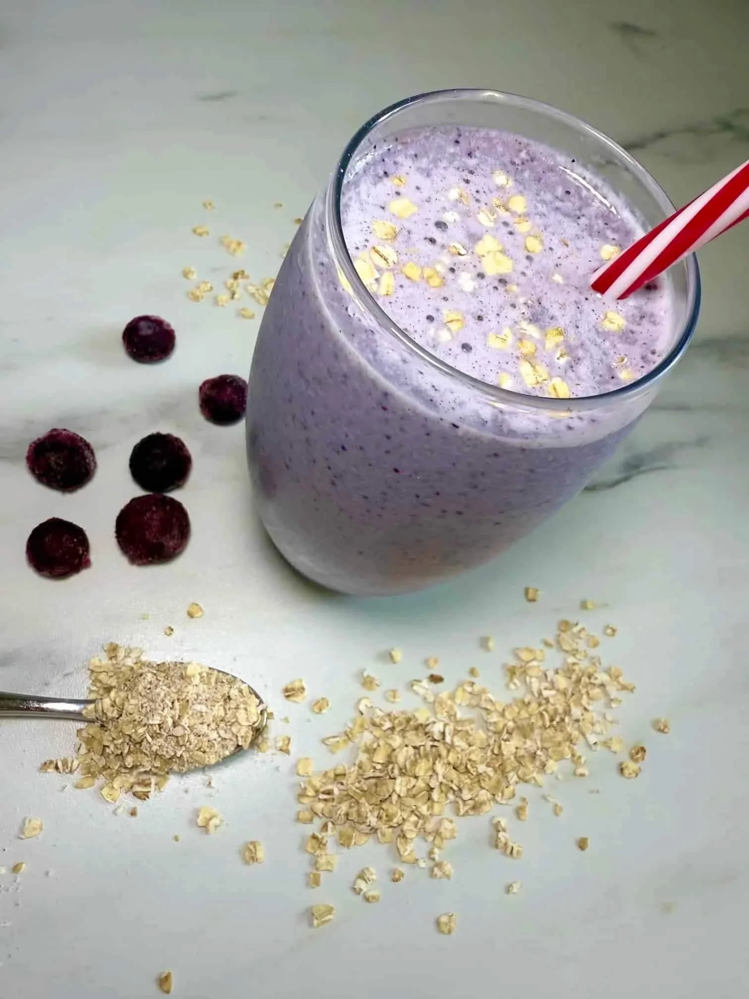 A glass of the lactation smoothie with blueberries and oats