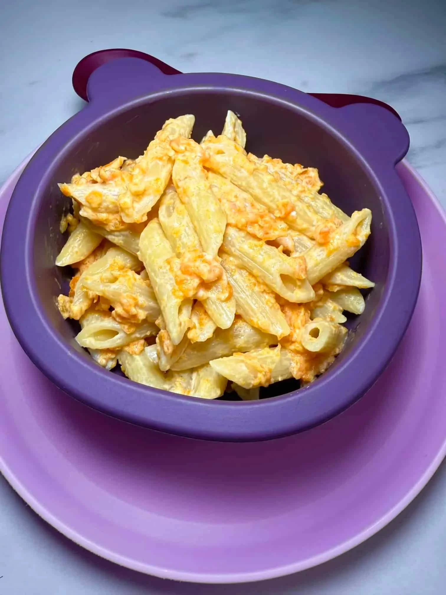 A toddler portion of pasta served with a creamy kid-friendly carrot pasta sauce