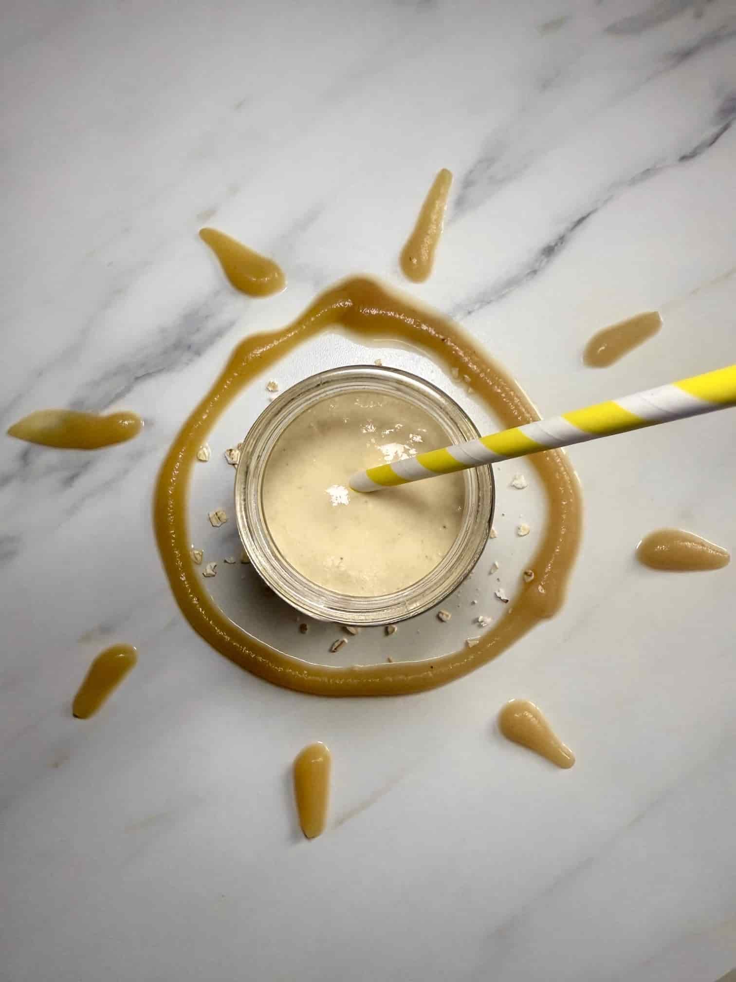 Apple and oat smoothie for baby and toddler served in a jar with a straw