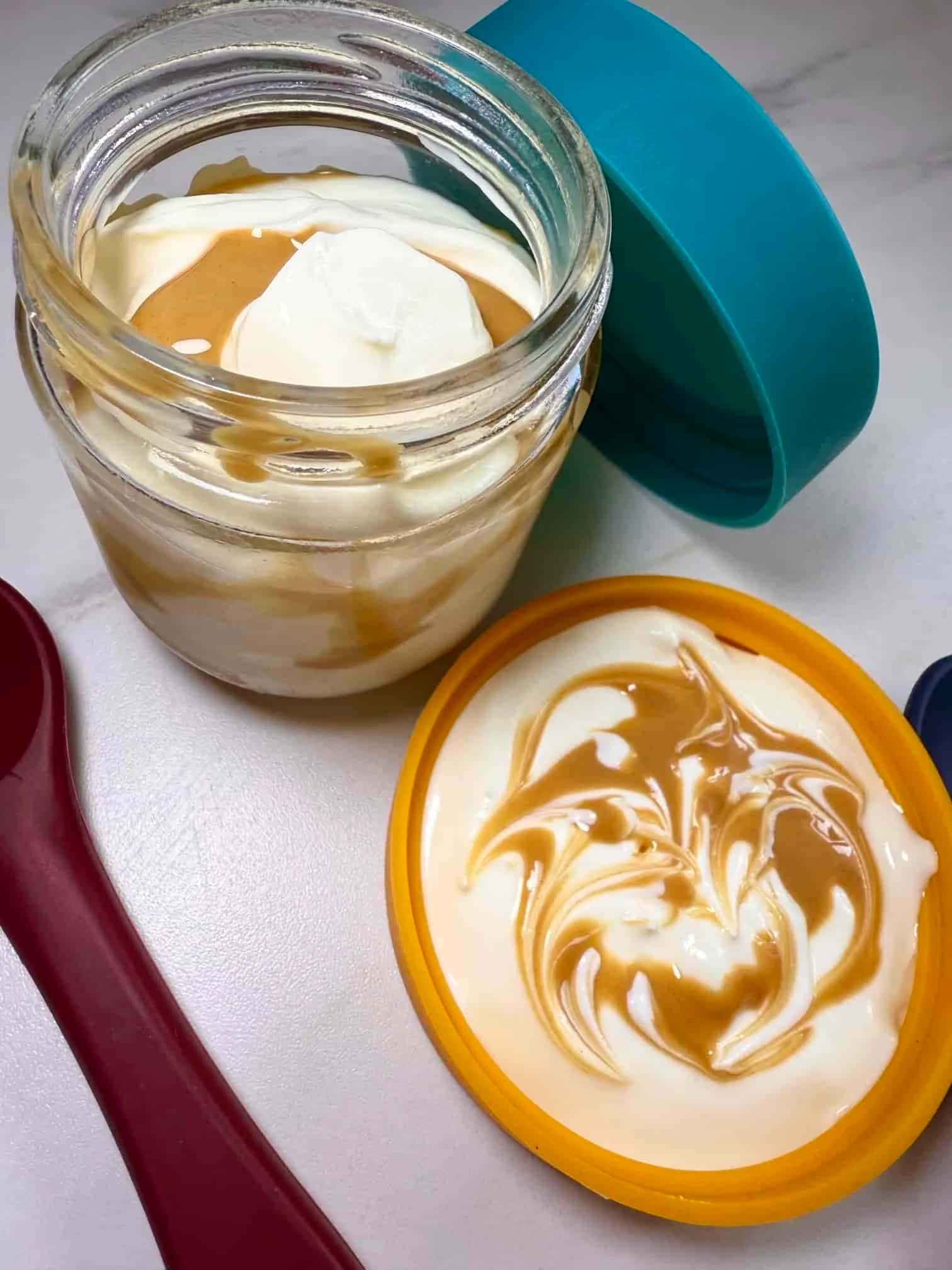 Greek yogurt swirled with peanut butter and served in a glass pot with a silicone lid