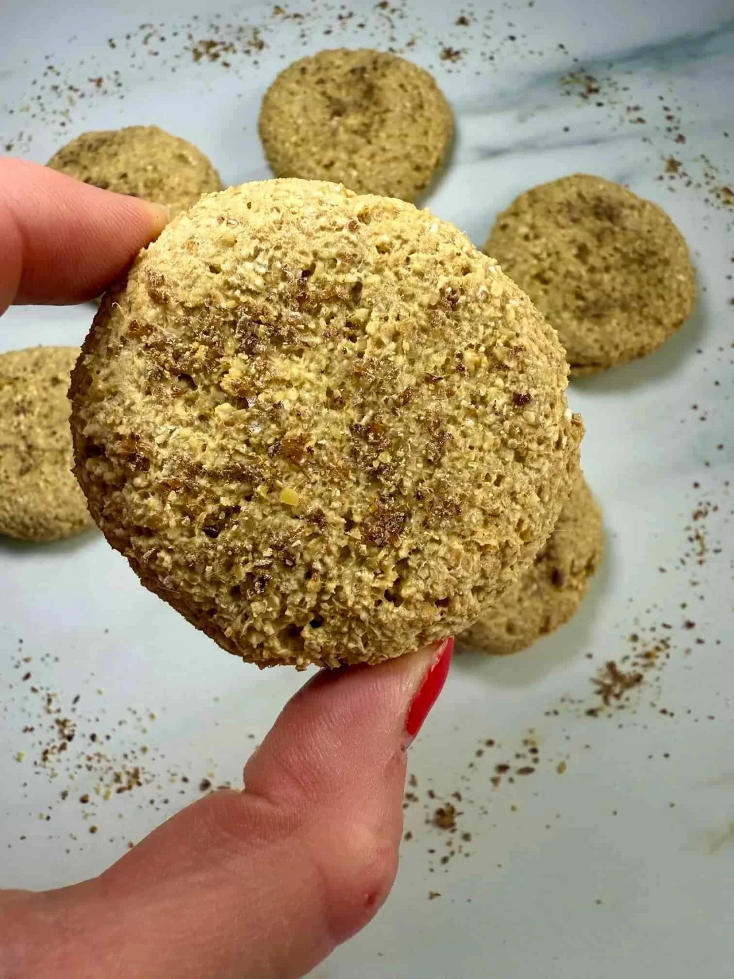 Close up image of a mango cookie, small enough for little baby fingers