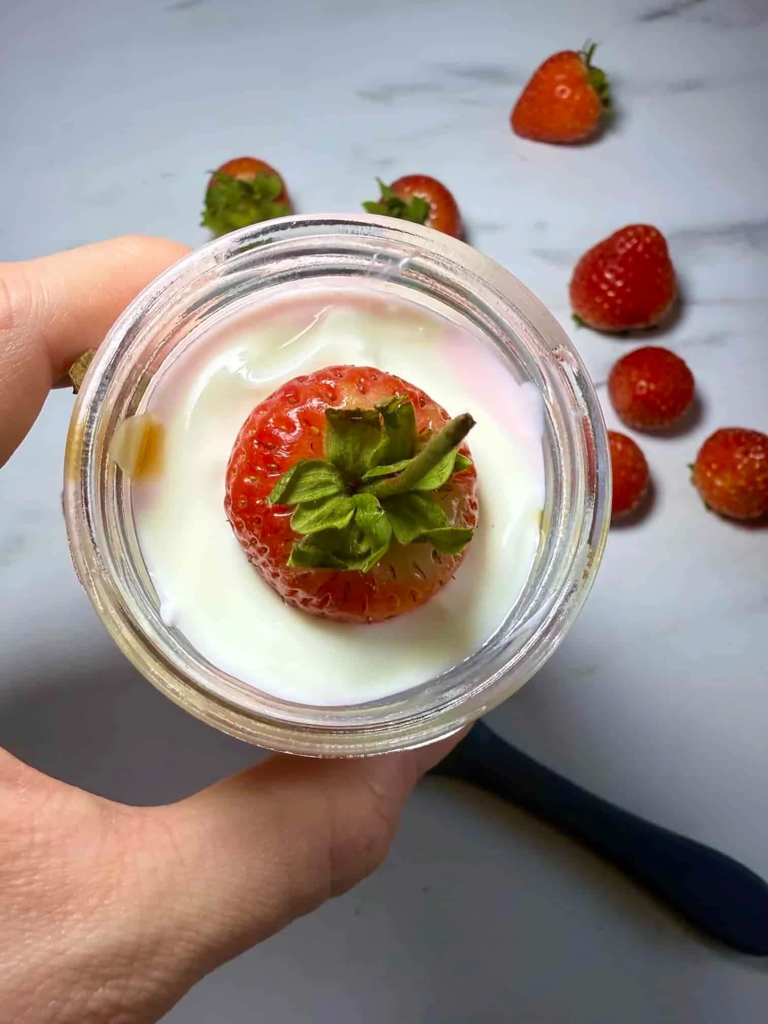 Cottage cheese, strawberries and Greek yogurt combined with a swirl of peanut butter and served in a jar with fresh strawberries