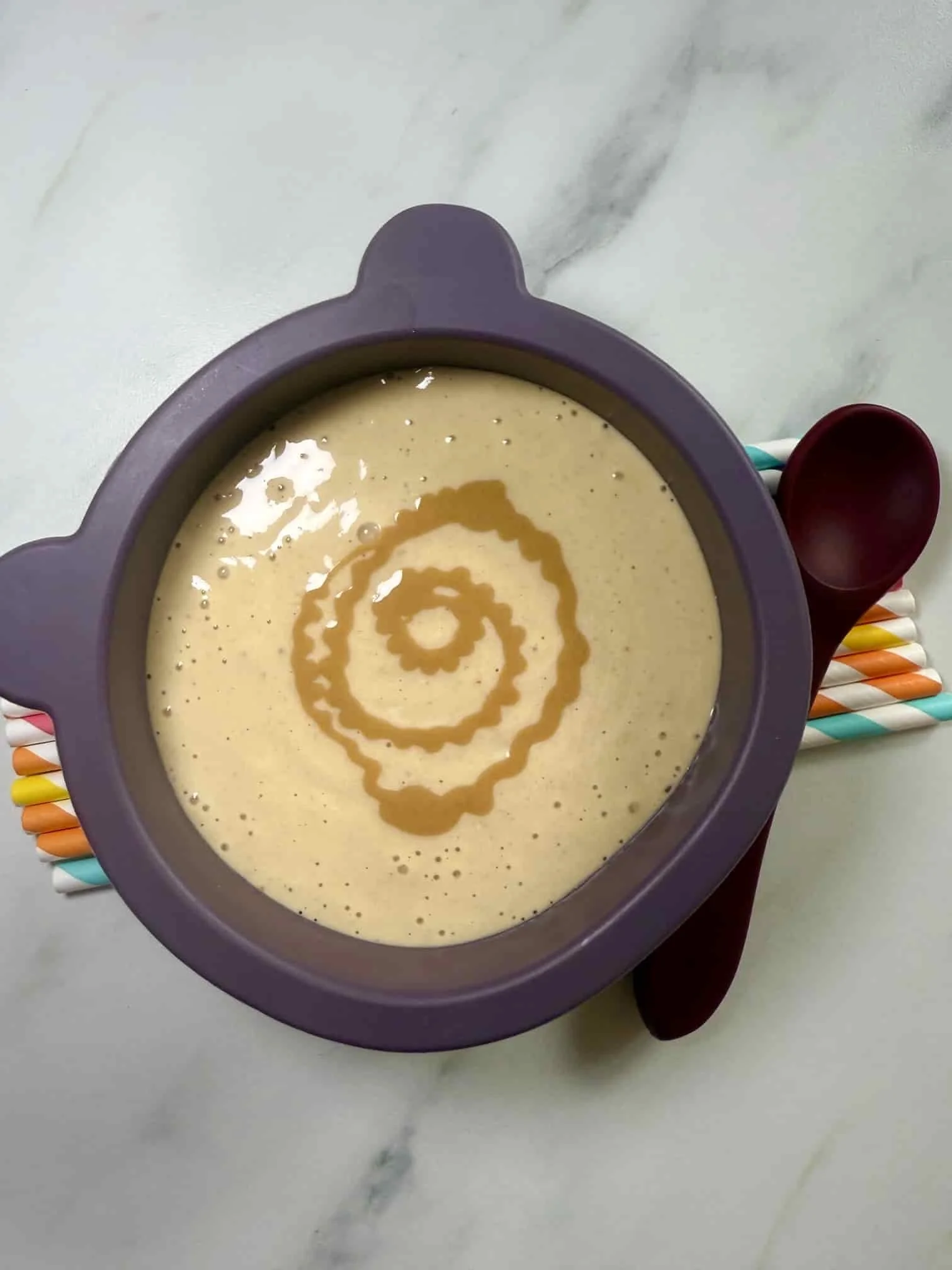 A serving of yogurt, peanut butter and banana smoothie served in a toddler bowl