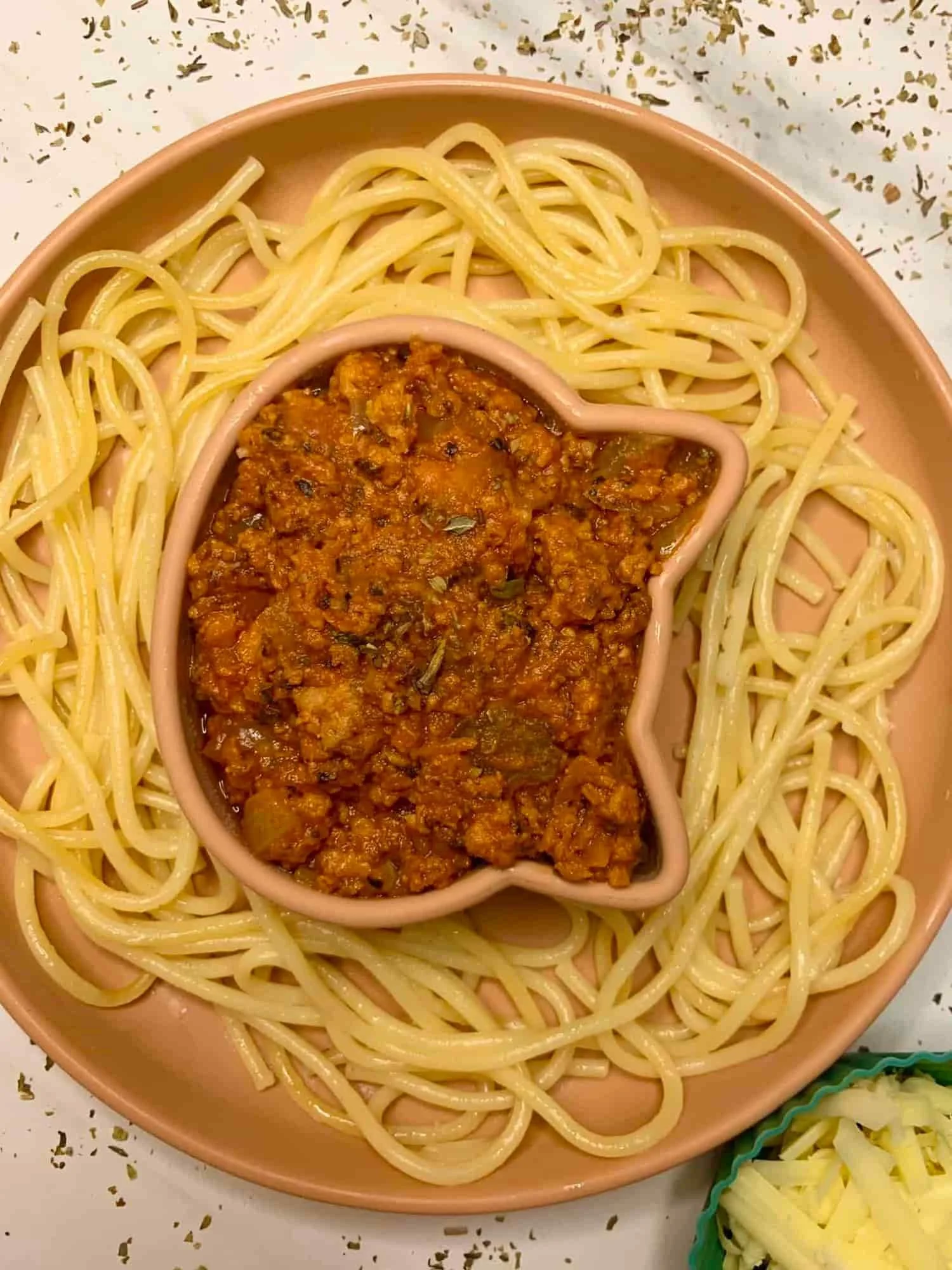 Slow cooked chicken spaghetti served in partitioned toddler bowl