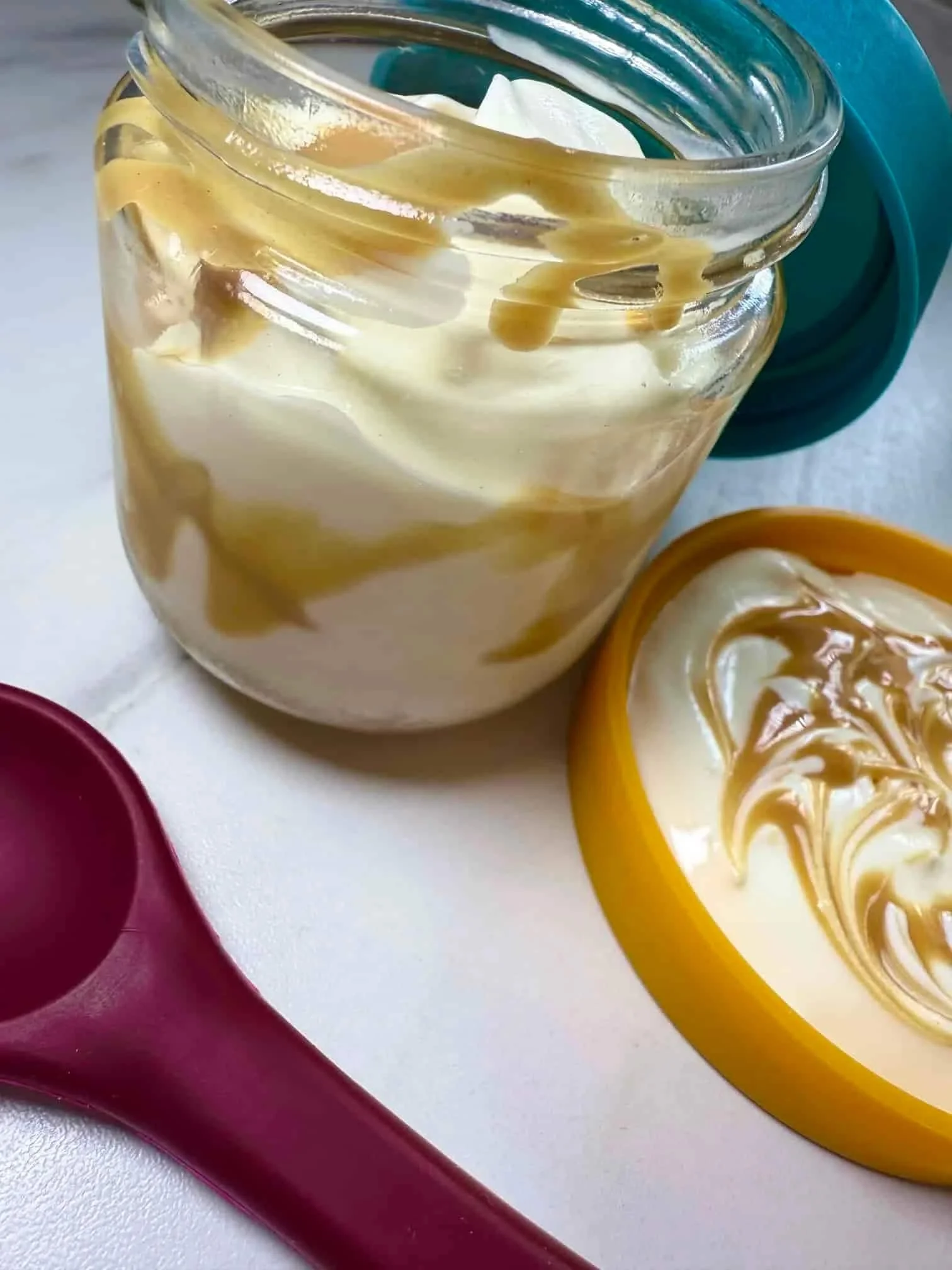 Greek yogurt swirled with peanut butter and served in a glass pot with a silicone lid